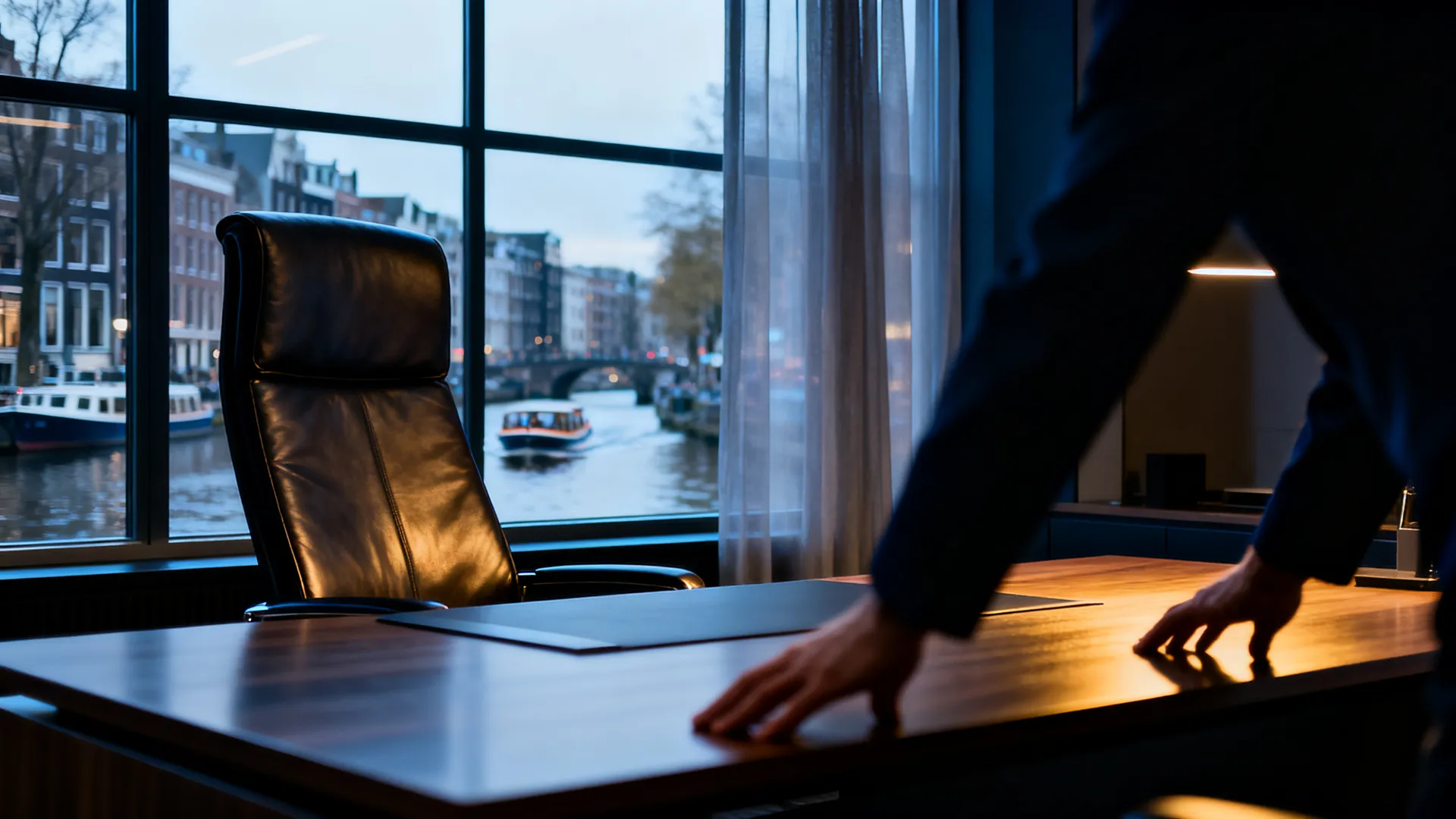 A modern executive office in Amsterdam with a canal view through the window