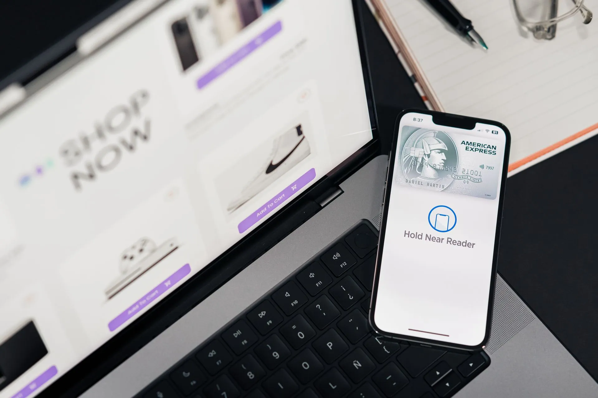 Smartphone with payment terminal app next to laptop displaying online shopping site, illustrating Meta launches Muse AI agent with Stripe Link as agentic commerce spreads