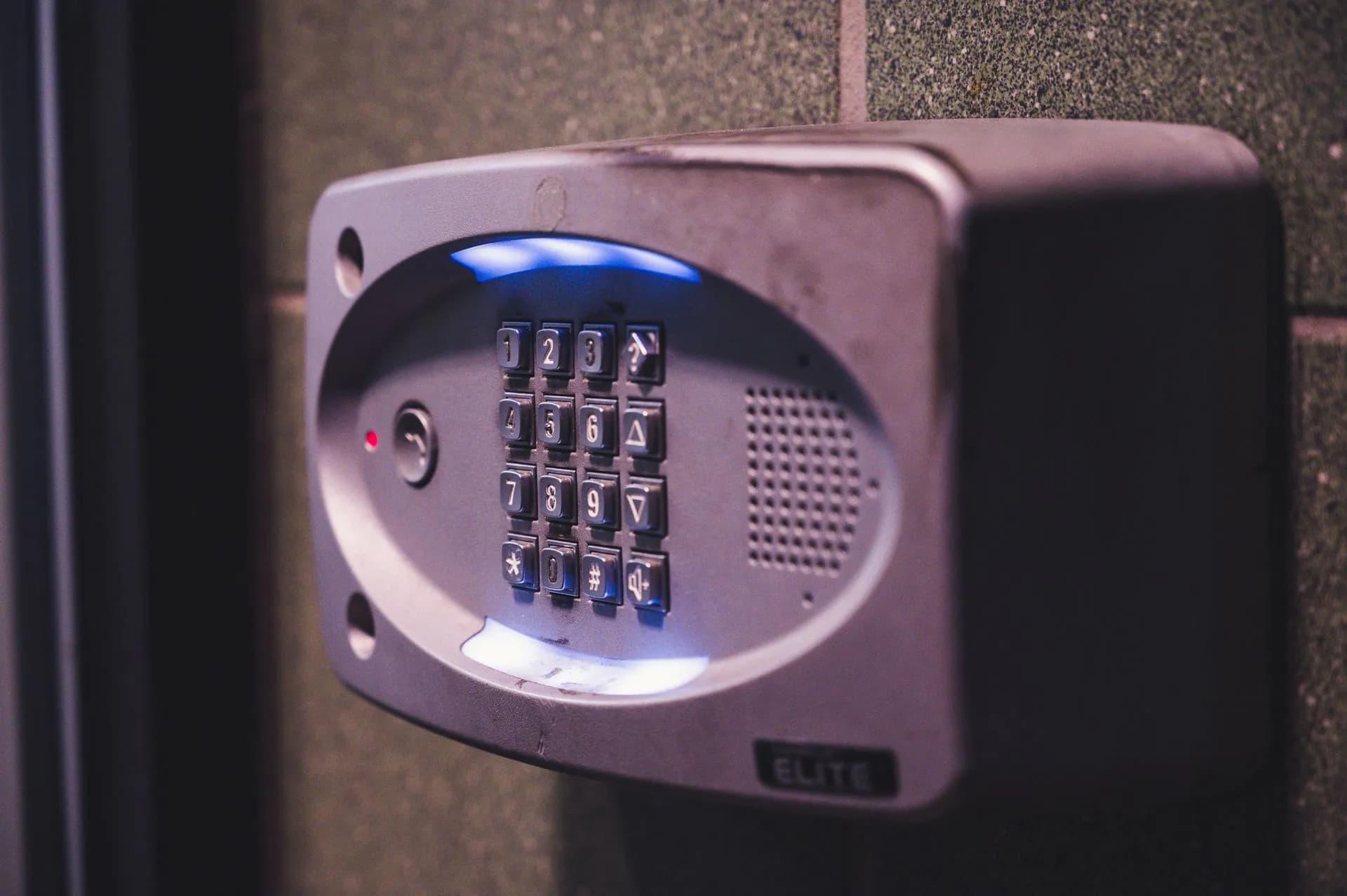 A close-up image of an illuminated security keypad mounted on a wall, illustrating AI agent access