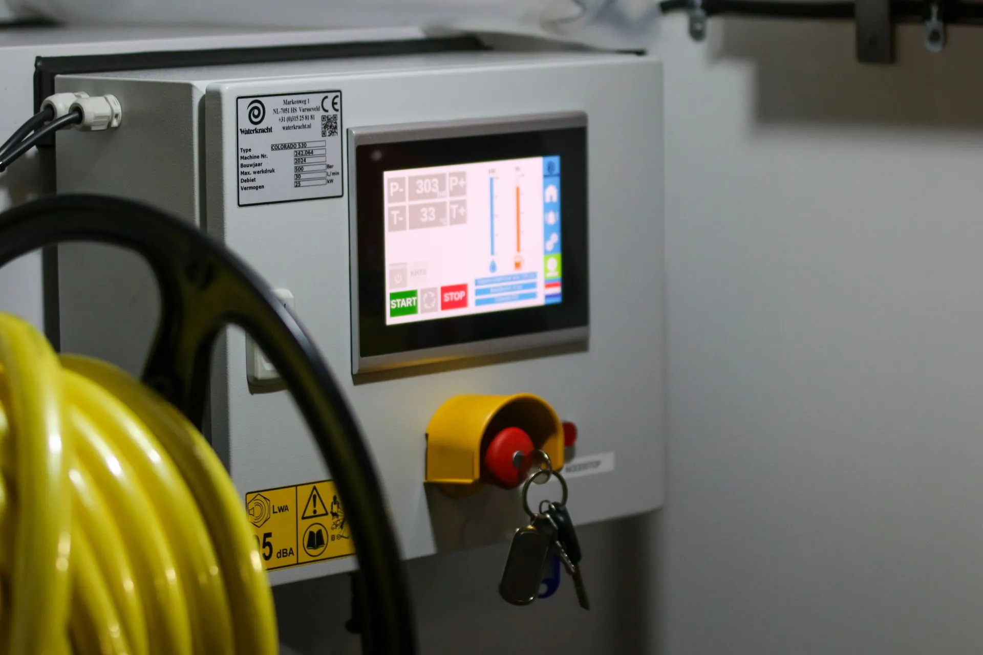 Close-up of an industrial control panel displaying safety features and a digital screen, illustrating AI agent safety lapses at OpenAI and Anthropic show why enterprises need hard