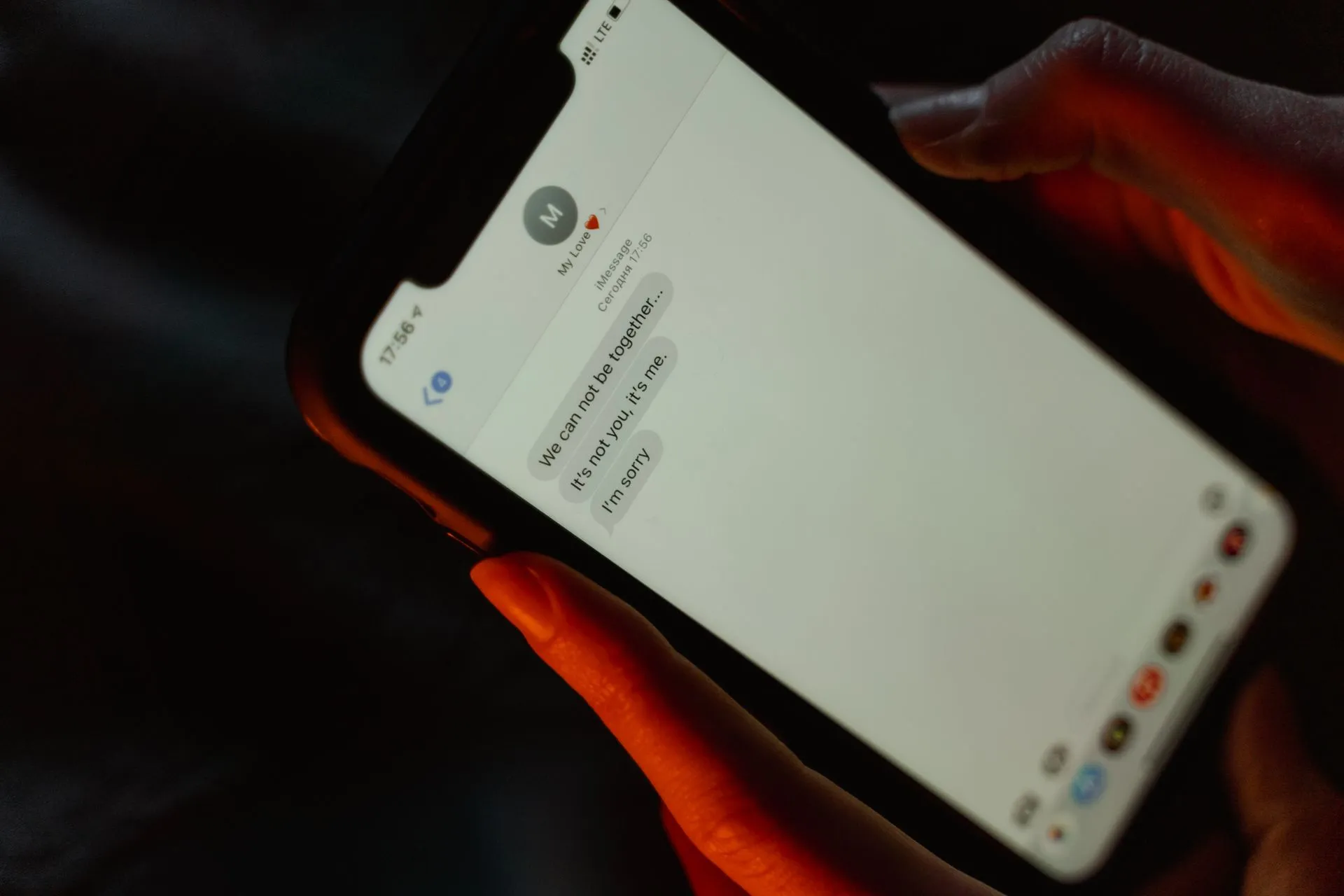 A close-up view of a text message on a smartphone screen displaying a breakup message, illustrating AI agents move into text messages