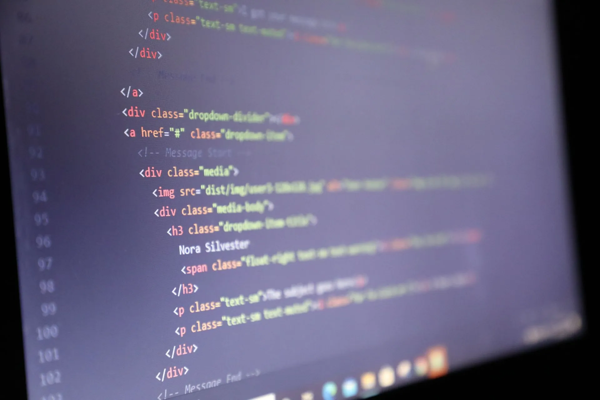 Illuminated HTML code displayed on a computer screen, close-up view, illustrating AI coding agents put 13,000+ internal company screenshots on public GitHub, Glow says