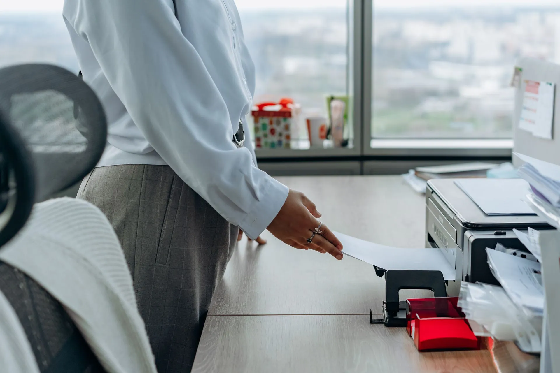 Business professional printing a document in an office environment, illustrating GreyNoise