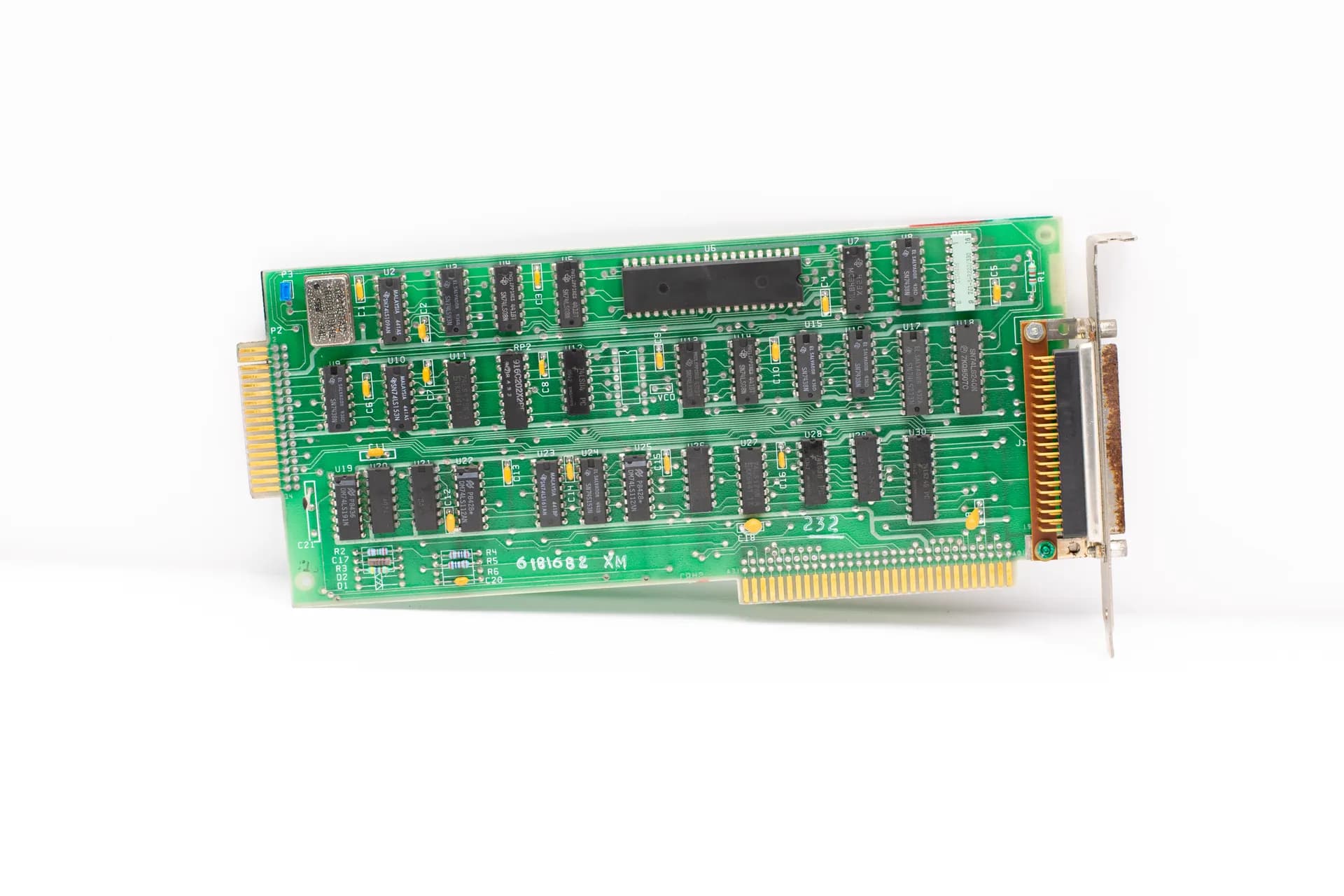 Close-up of a vintage computer circuit board highlighting chips and connectors, illustrating Markets price in a 32.6% AI productivity jump for coders