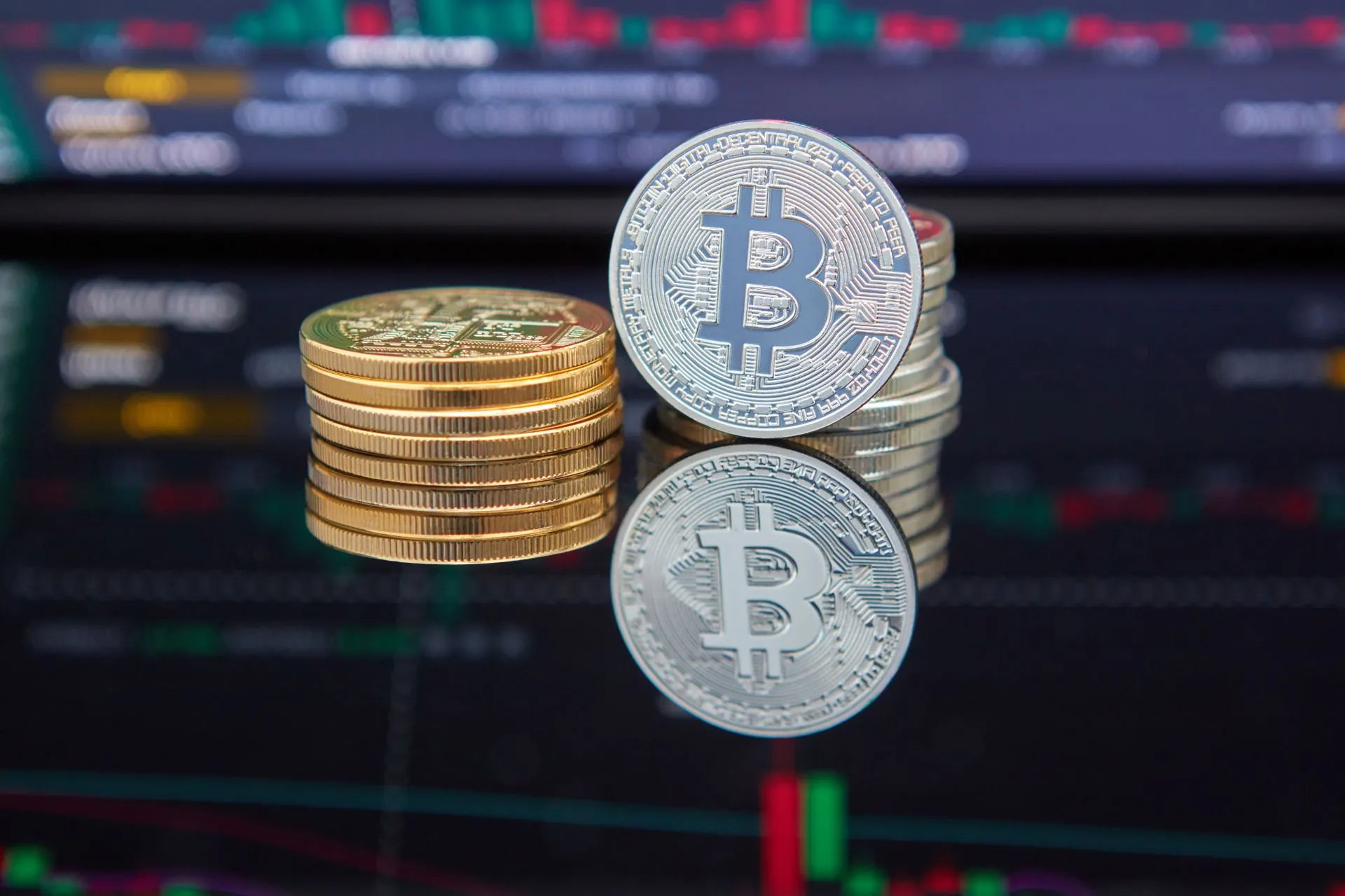 Bitcoin coins stacked in front of cryptocurrency trading chart reflecting market trends, illustrating AI ROI squeeze