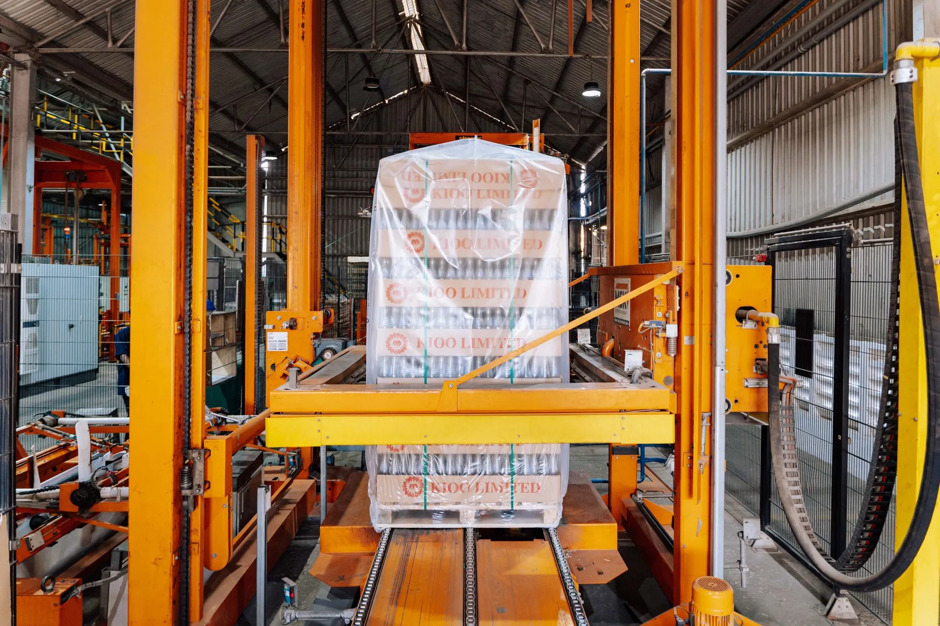 An industrial machine in a glass factory showcasing automated packaging in Dar es Salaam, illustrating Amazon warehouse workers strike in New York over safety and belt speeds