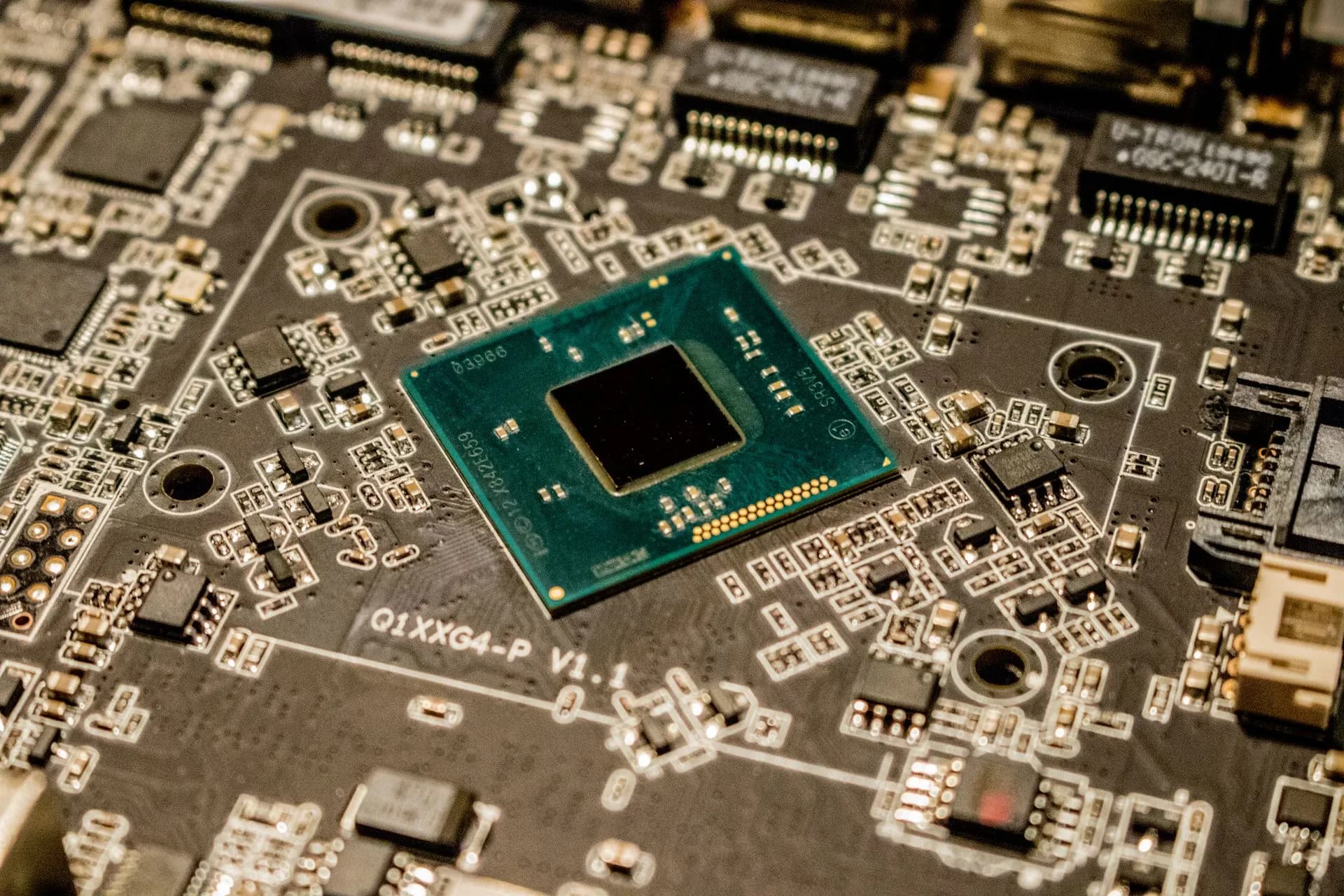 Detailed view of a microchip on a printed circuit board, showcasing electronic components, illustrating AMD agrees to $8.2 billion World Labs acquisition, bringing in Fei-Fei Li