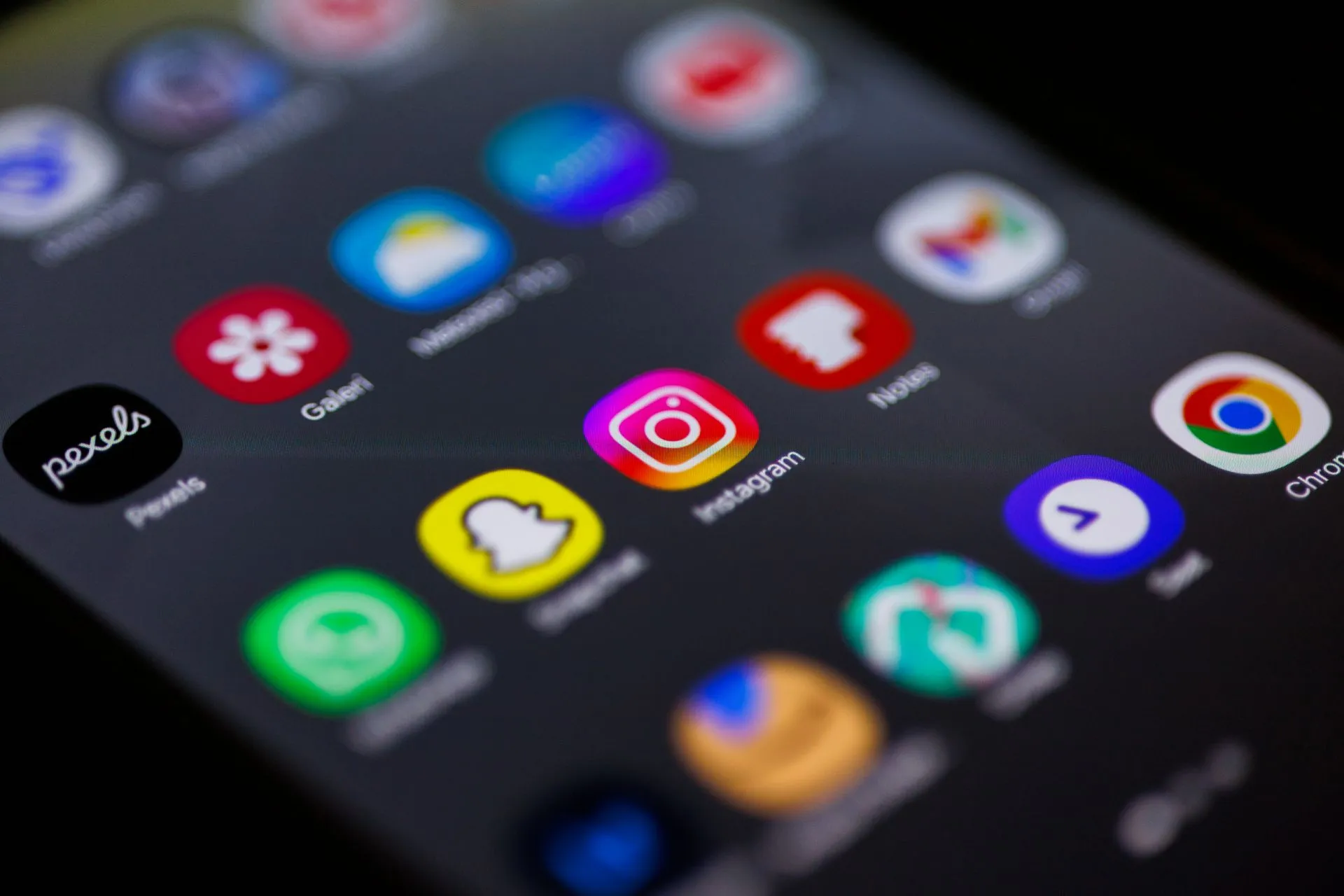 Close-up view of smartphone home screen featuring popular apps like Instagram, Snapchat, and Chrome, illustrating Anthropic threat report says hackers used Claude in a scan of 1.8