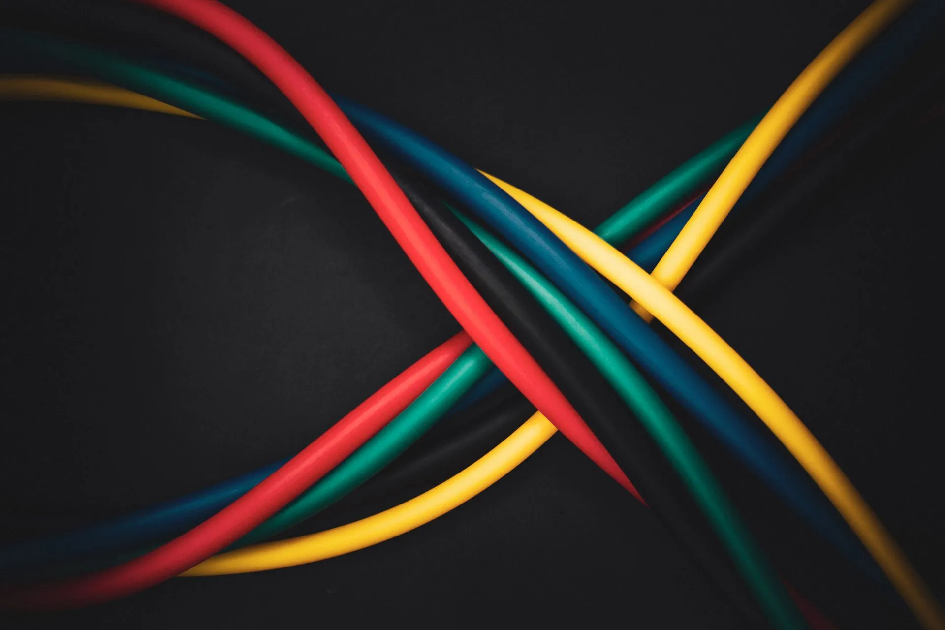 Multi-colored cables intertwined against a dark background, showing technology connections, illustrating Azure outage hit VPN and ExpressRoute gateways after a Microsoft software change