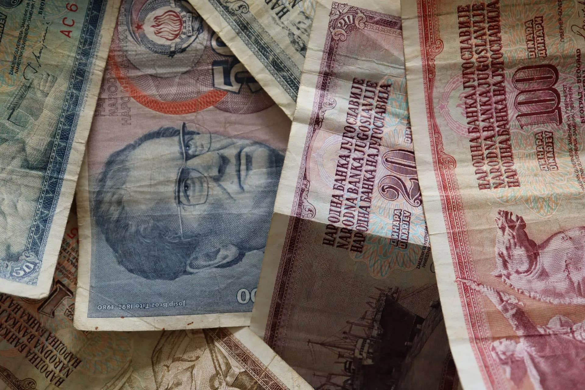 A close-up photo of diverse vintage banknotes, showcasing historical currency from different countries, illustrating Bank of America cross-border real-time payments