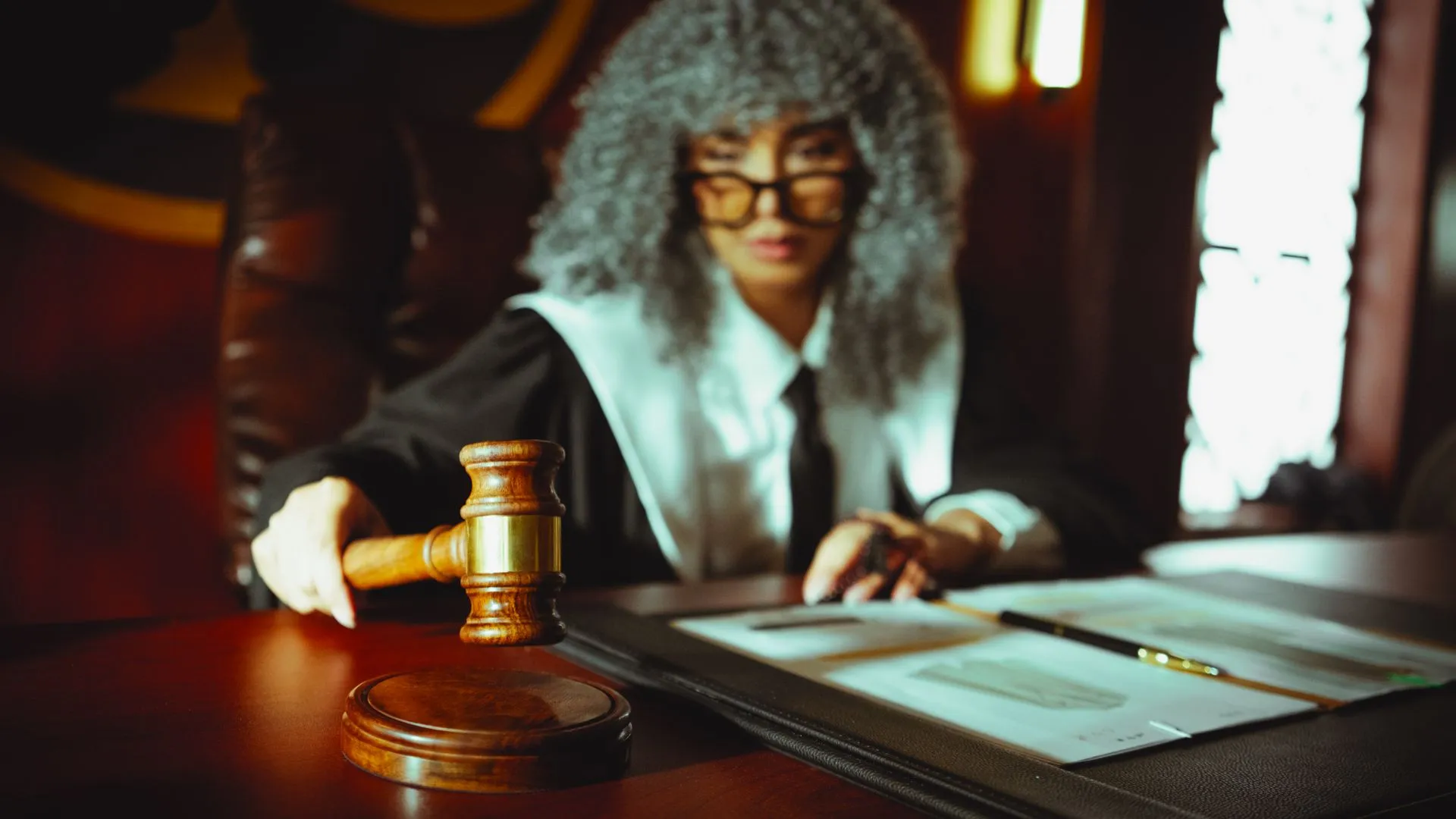 A judge in a courtroom holding a gavel, focused on legal documents, illustrating California serves OpenAI subpoena over AI cyber incidents