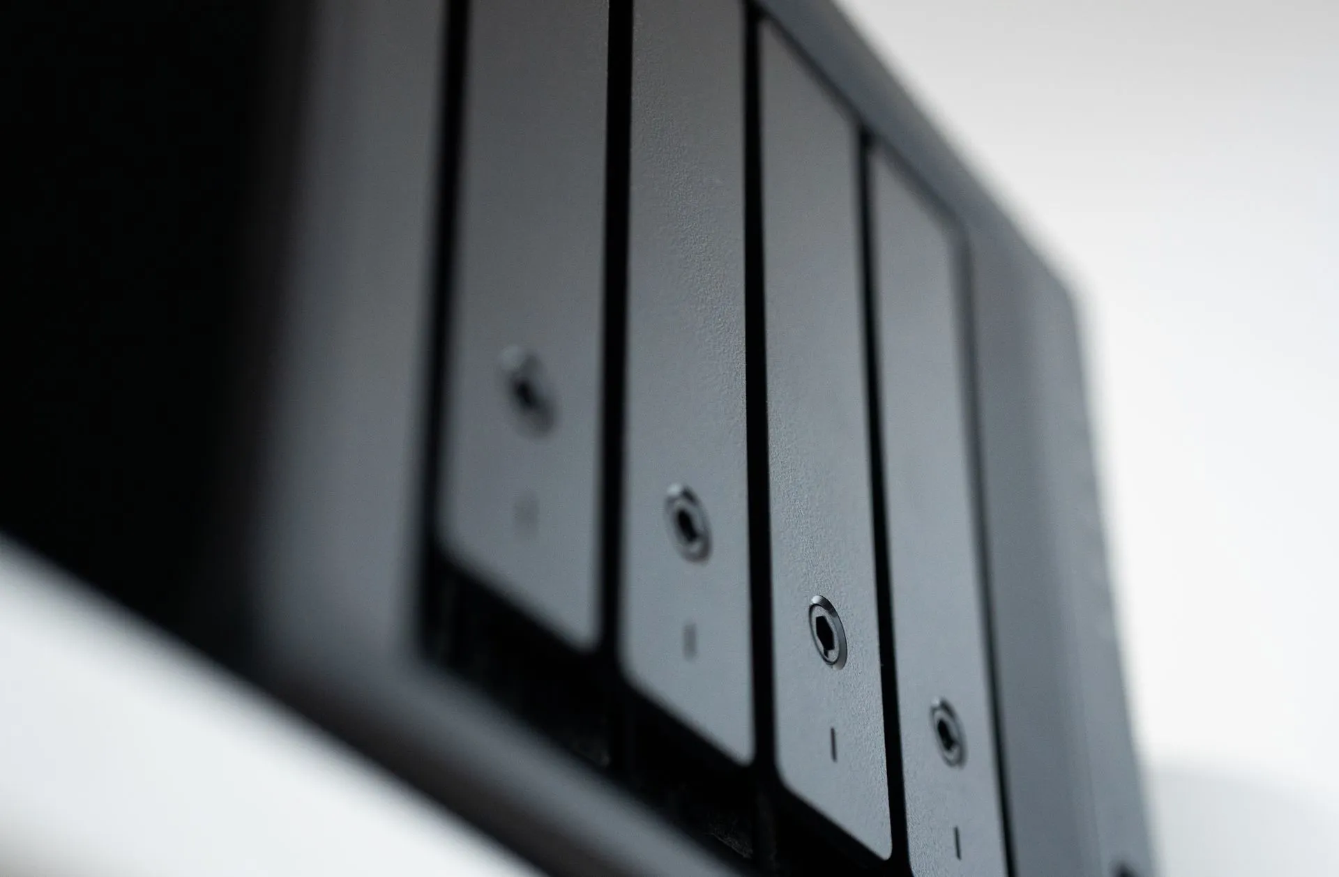 Detailed view of a black data storage unit highlighting modern technology and data management, illustrating Carbonato botnet plants Hermes AI agent on exposed Docker hosts, ThreatDown