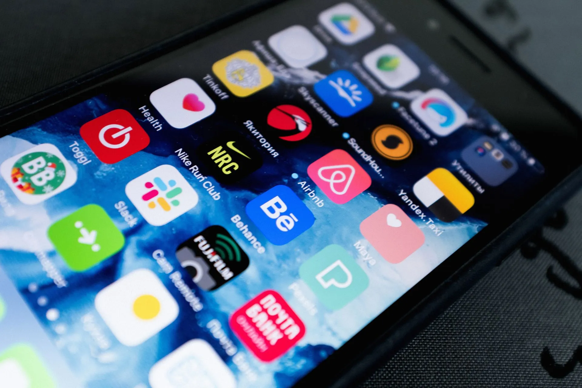 Detailed view of smartphone displaying multiple app icons on screen, highlighting technology use, illustrating ChatGPT plugins turn app-like as OpenAI launches sign-in and an