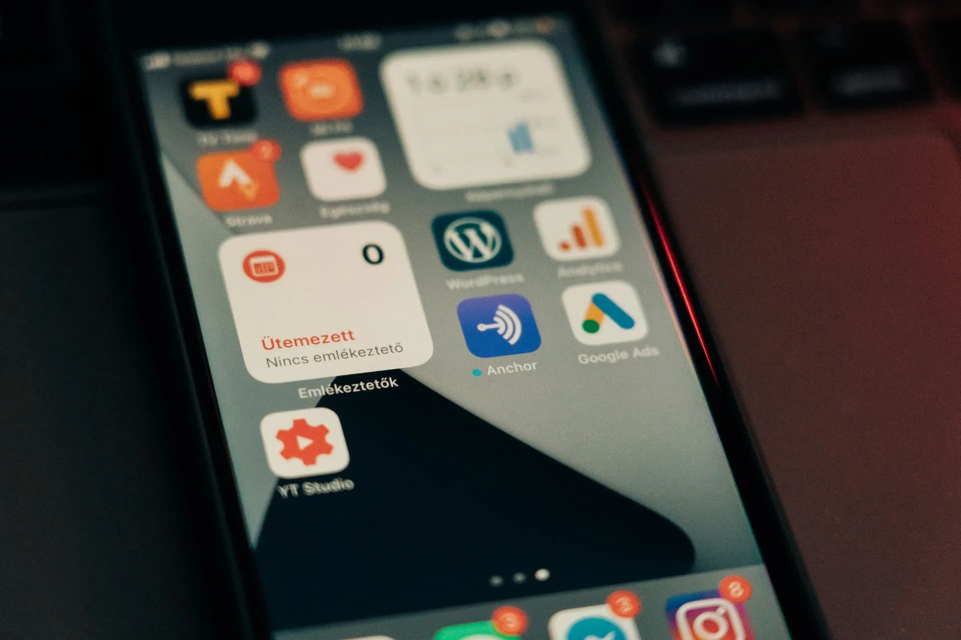 Close-up view of smartphone screen featuring various app icons and notifications, illustrating OpenAI to show visual ads beside ChatGPT image results in the US, adds measurement