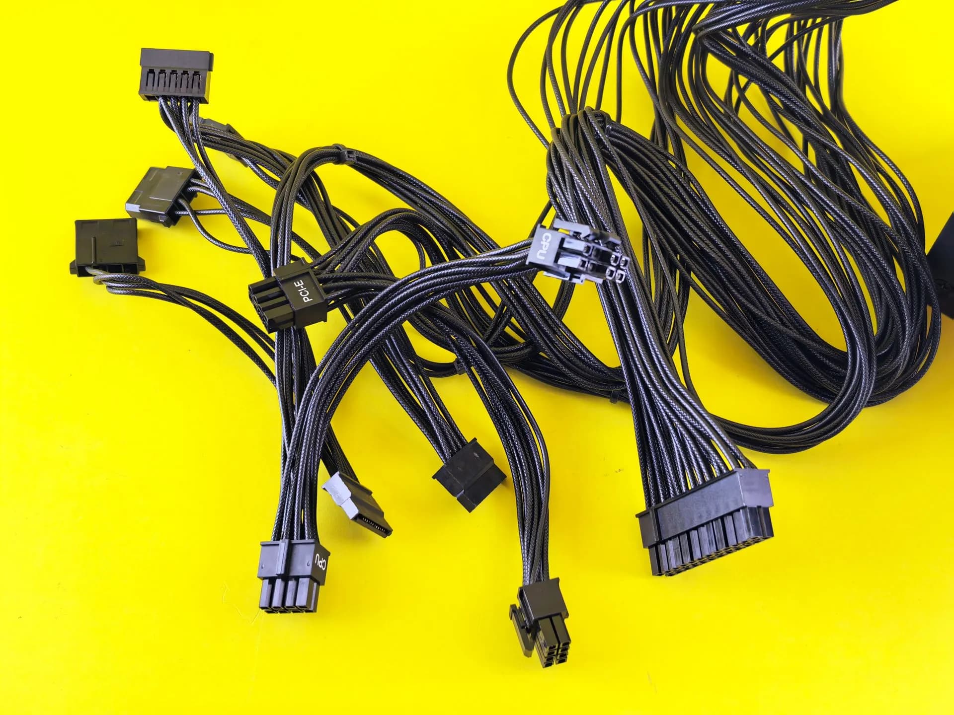 Black computer cables splayed on a vibrant yellow surface, highlighting technology connection themes, illustrating Citrix NetScaler hackers struck weeks before customers were warned