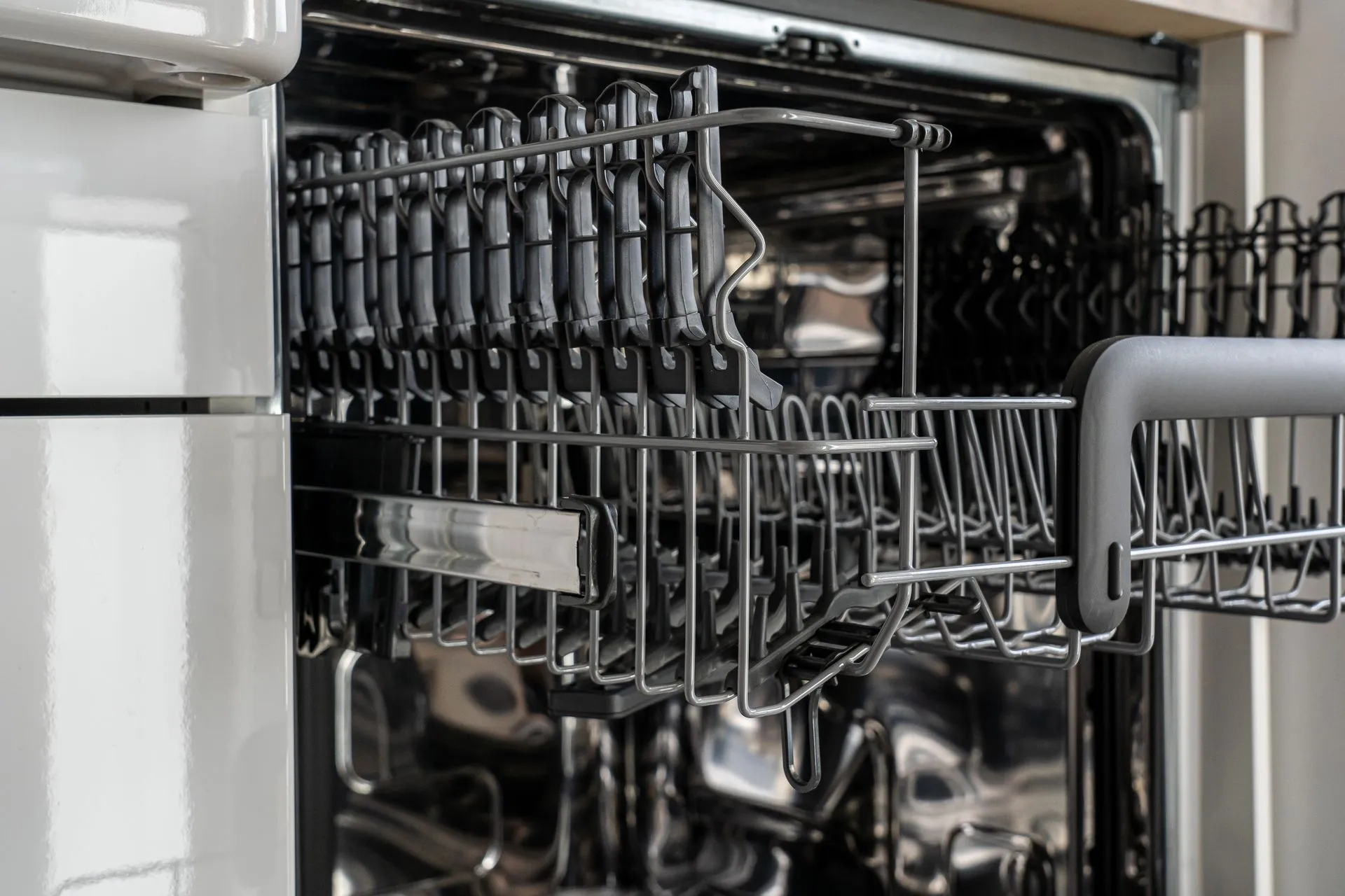 A detailed view of an empty modern dishwasher rack showcasing its stainless steel construction, illustrating Citrix NetScaler zero-day in SAML setups is third exploited flaw