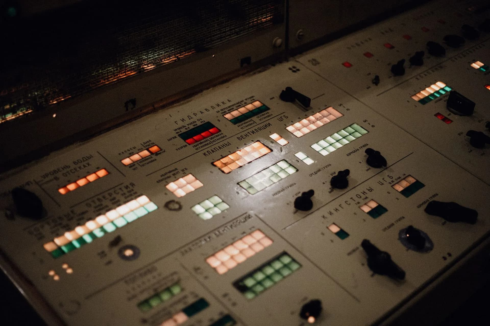 Close-up of an illuminated vintage control panel with various buttons and switches, illustrating Cohere North 2 adds org-wide token spending caps and autonomy limits for enterprise