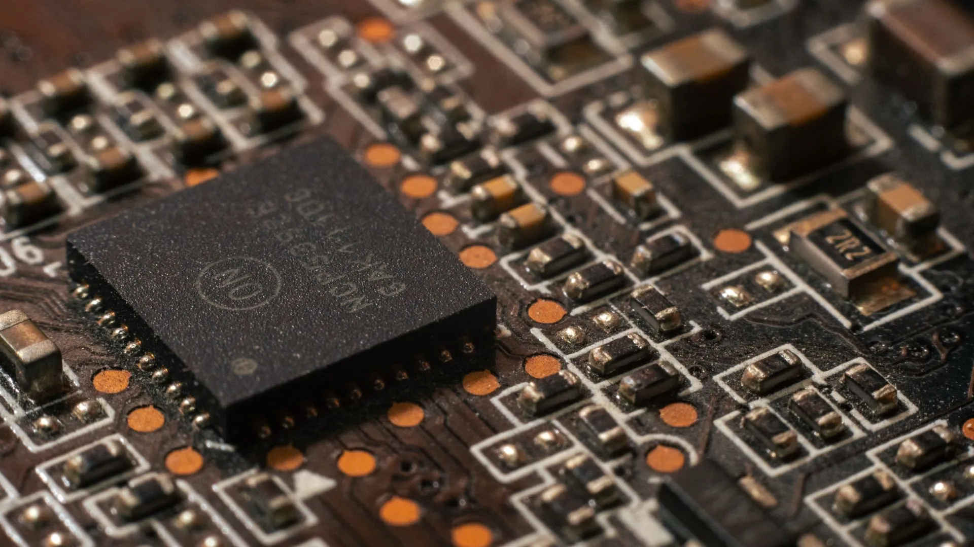 Detailed close-up of a computer circuit board showcasing electronic components, illustrating CoreWeave launches Forge, a platform that turns production AI runs into better models