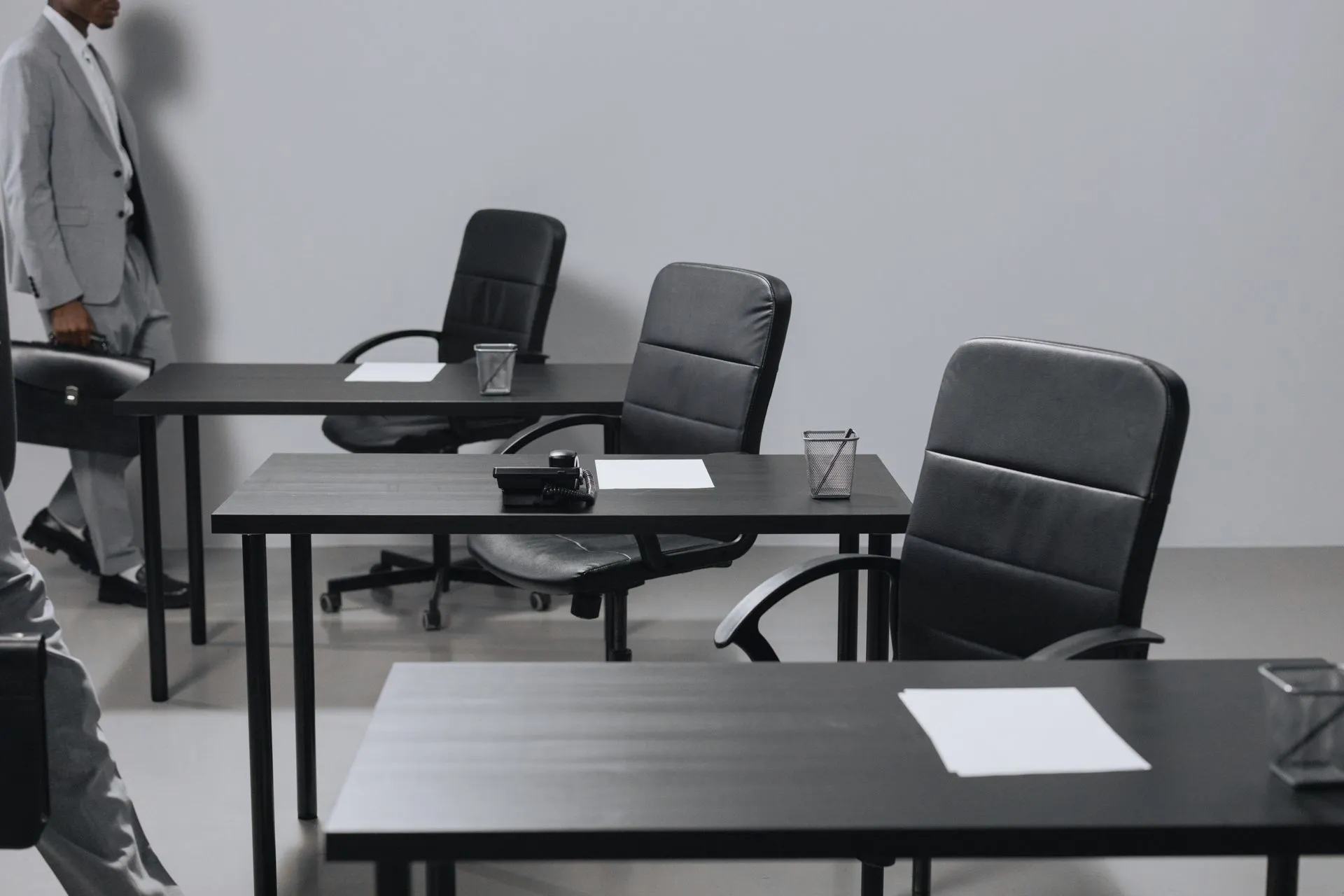 Contemporary office space with black leather chairs and desks, showcasing a minimalist design, illustrating DayOne files for a Nasdaq IPO after first-half revenue jumps to $512 million