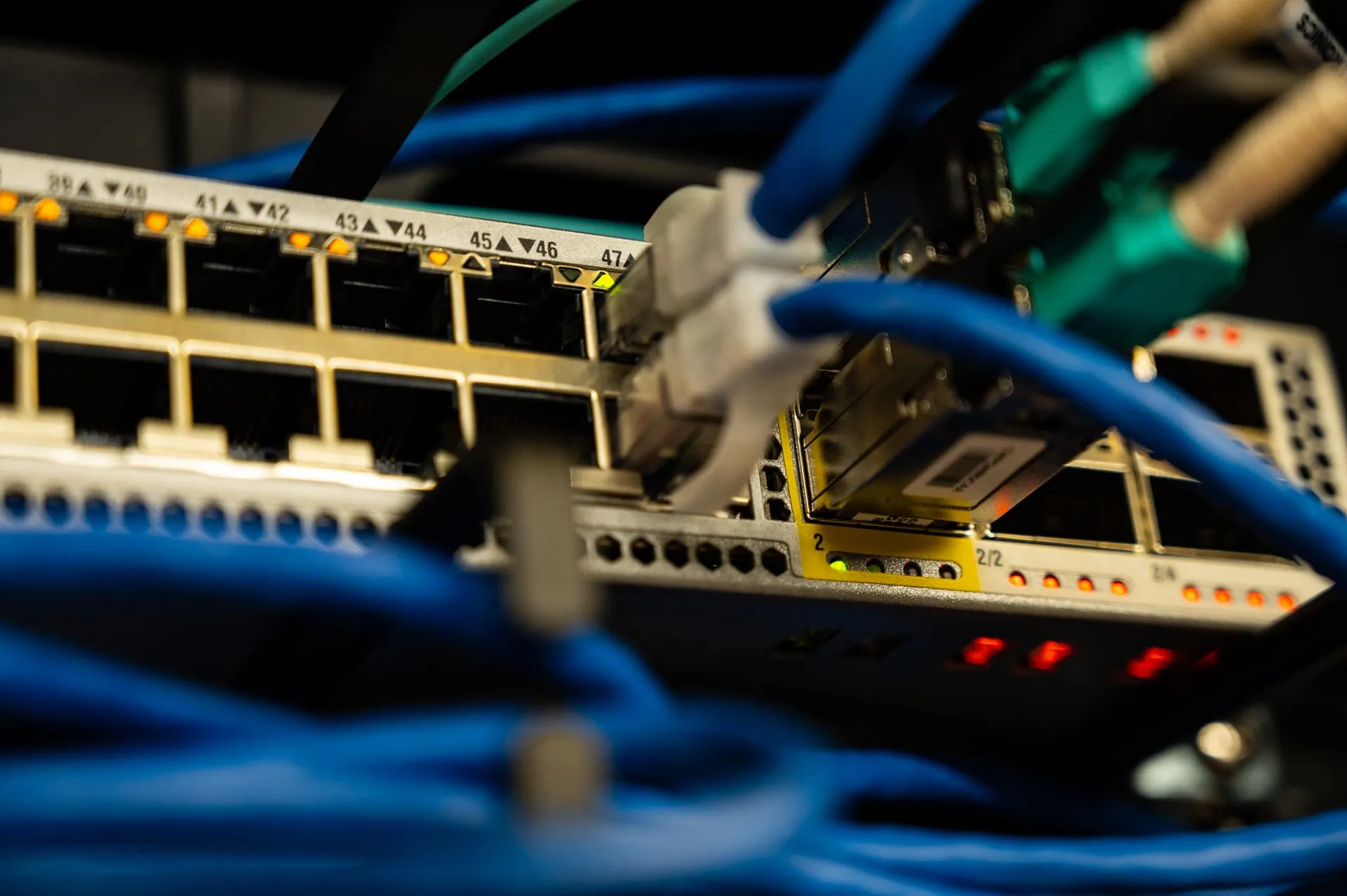 Close-up image of ethernet cables plugged into a network switch, showcasing IT infrastructure, illustrating Edge device exploitation piles up as Check Point, Cisco and Citrix flaws hit