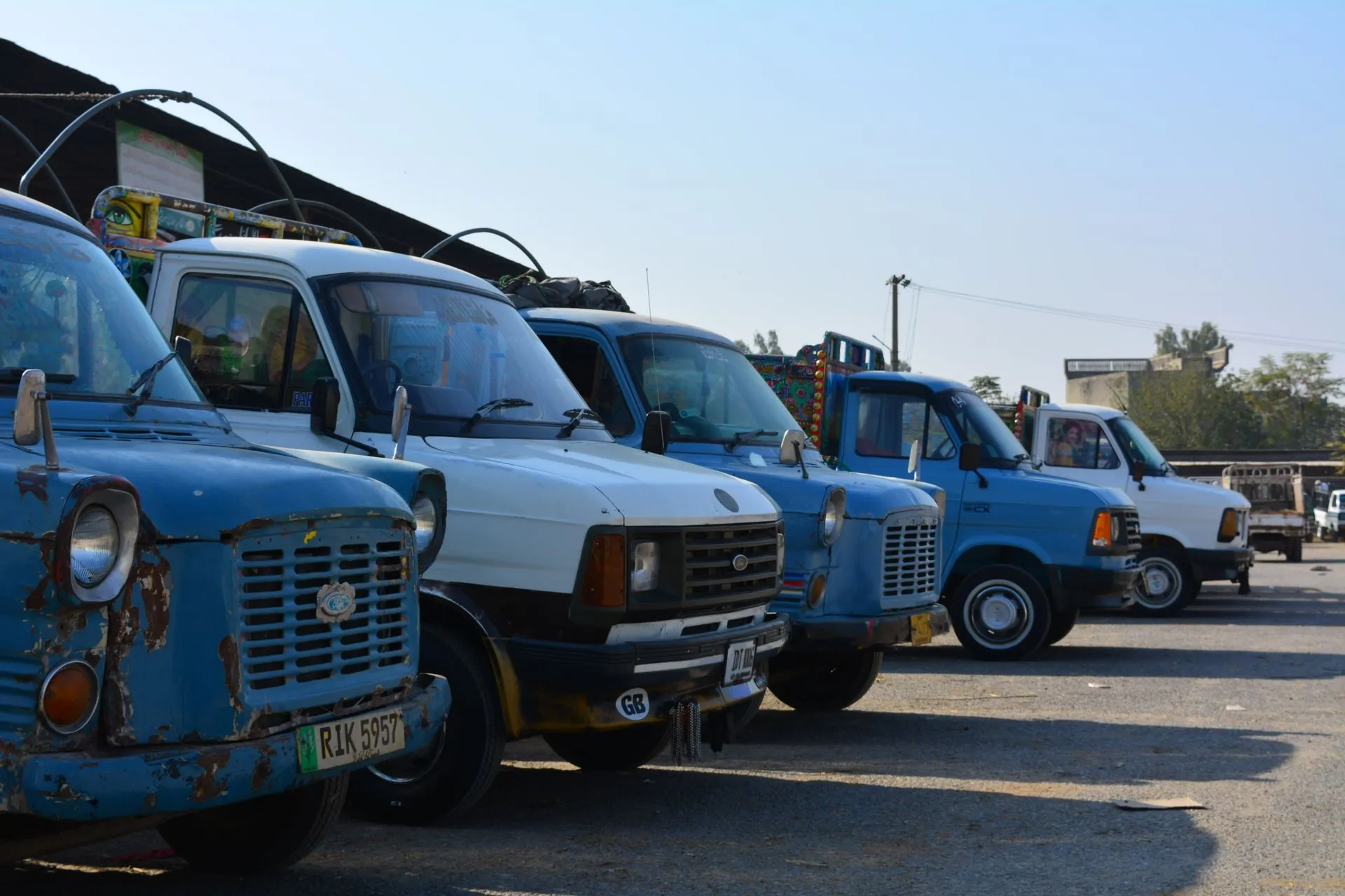 A collection of classic Ford vans parked in Taxila, showcasing vintage automotive design, illustrating env zero launches autonomous cloud control plane as Force Fleet debuts AI manager