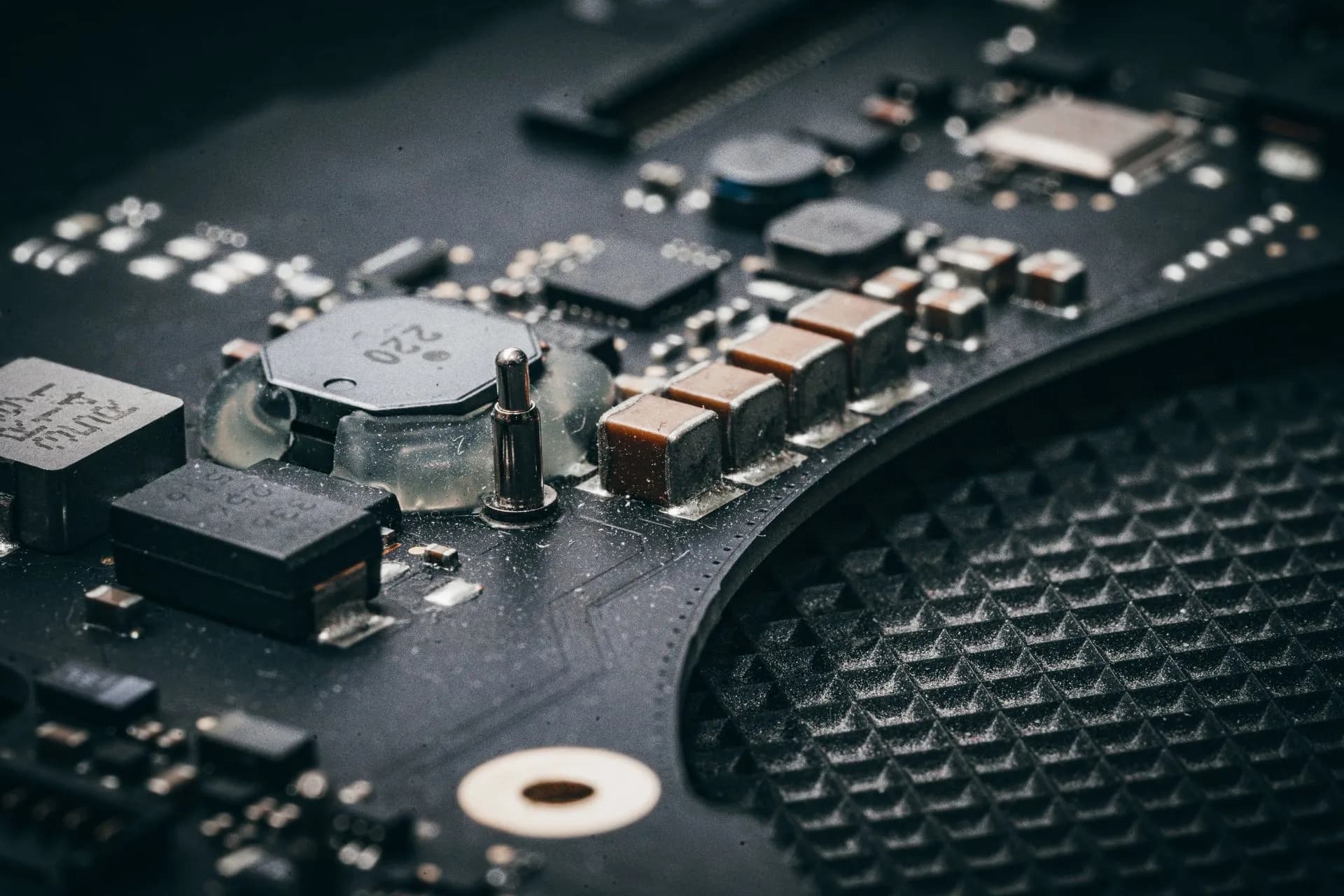 Detailed macro shot of an electronic circuit board showcasing various components, illustrating Etched weighs funding offers valuing the AI chipmaker at $40 billion or more