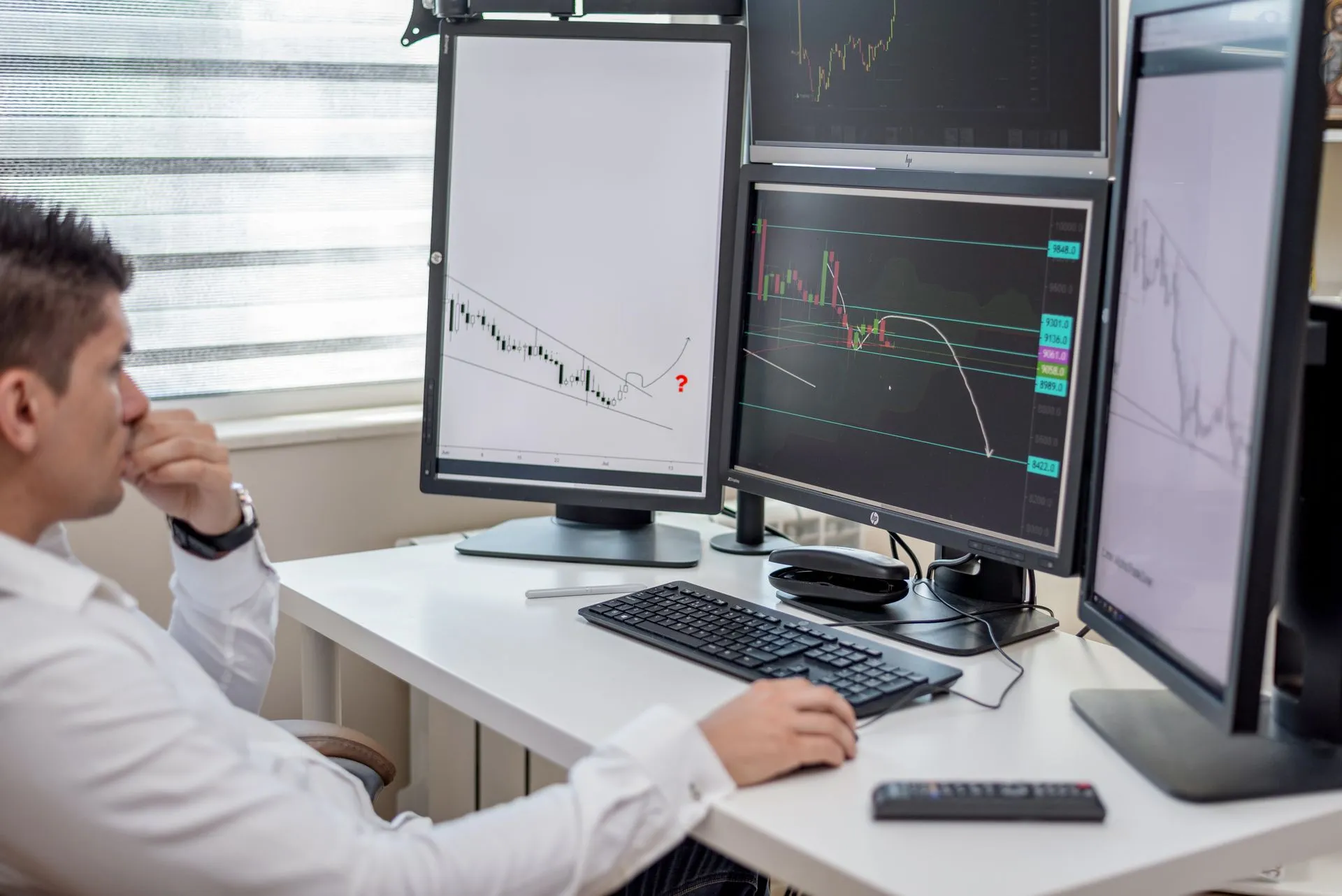Business professional analyzing financial data on multiple computer monitors at his workspace, illustrating FactSet fiscal Q4 organic ASV growth hits 7.0% as AI solutions ASV added