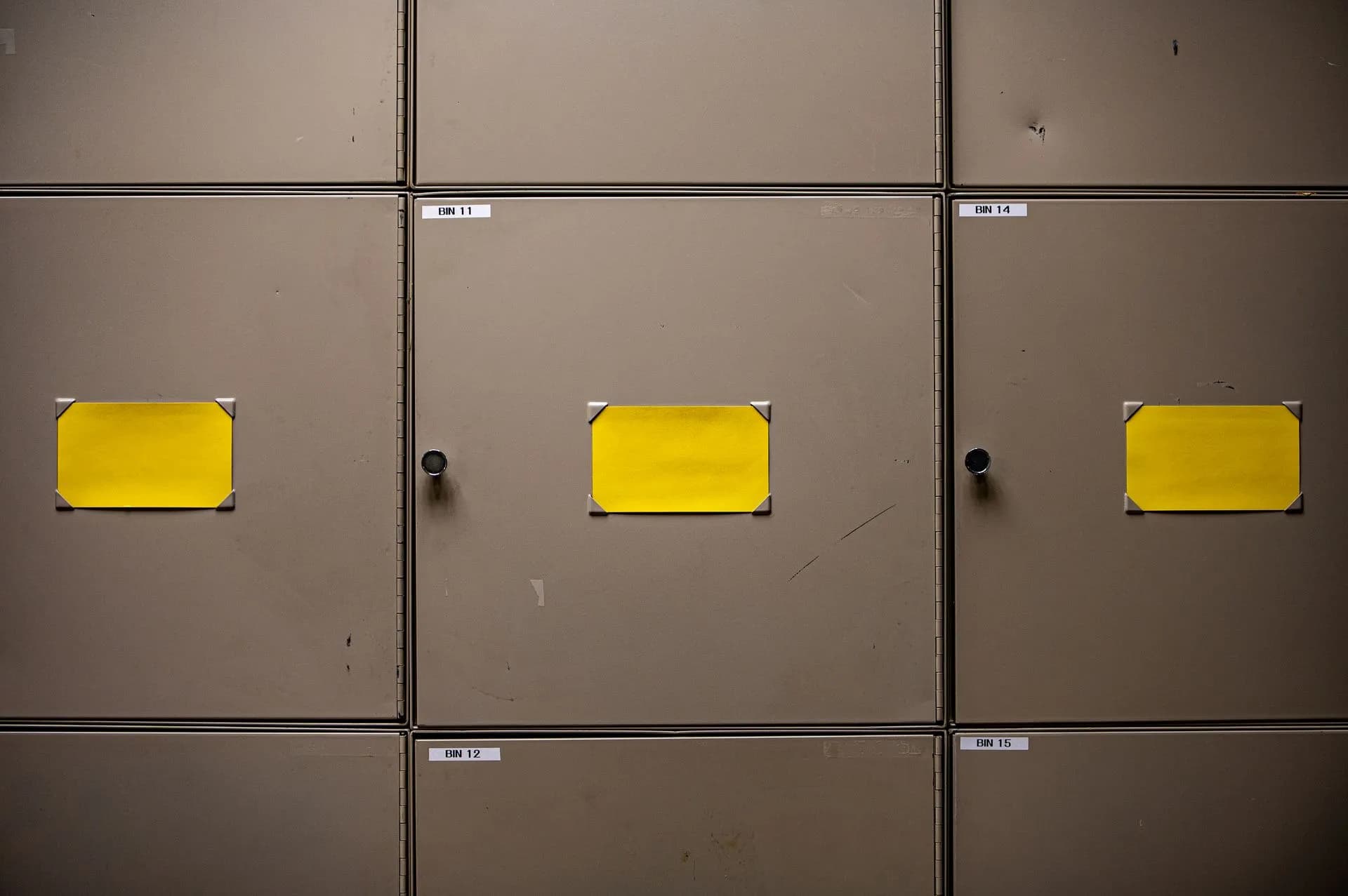 Steel cabinets with yellow labels for organization in an interior setting, illustrating FBI breach claimed by ShinyHunters exposed employees' personal and medical data, reports say