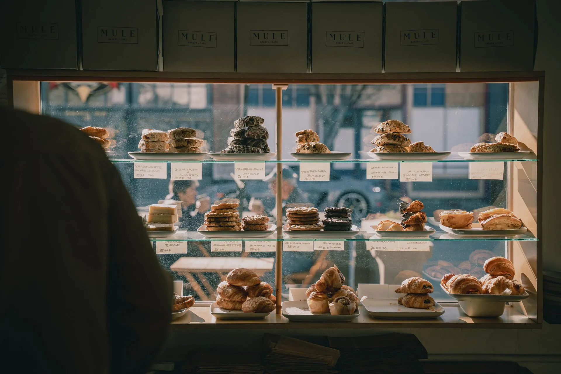 Inviting bakery display with assorted pastries and desserts capturing the warm ambiance of a cozy café, illustrating Froda enters France with Shine, offering same-day small business