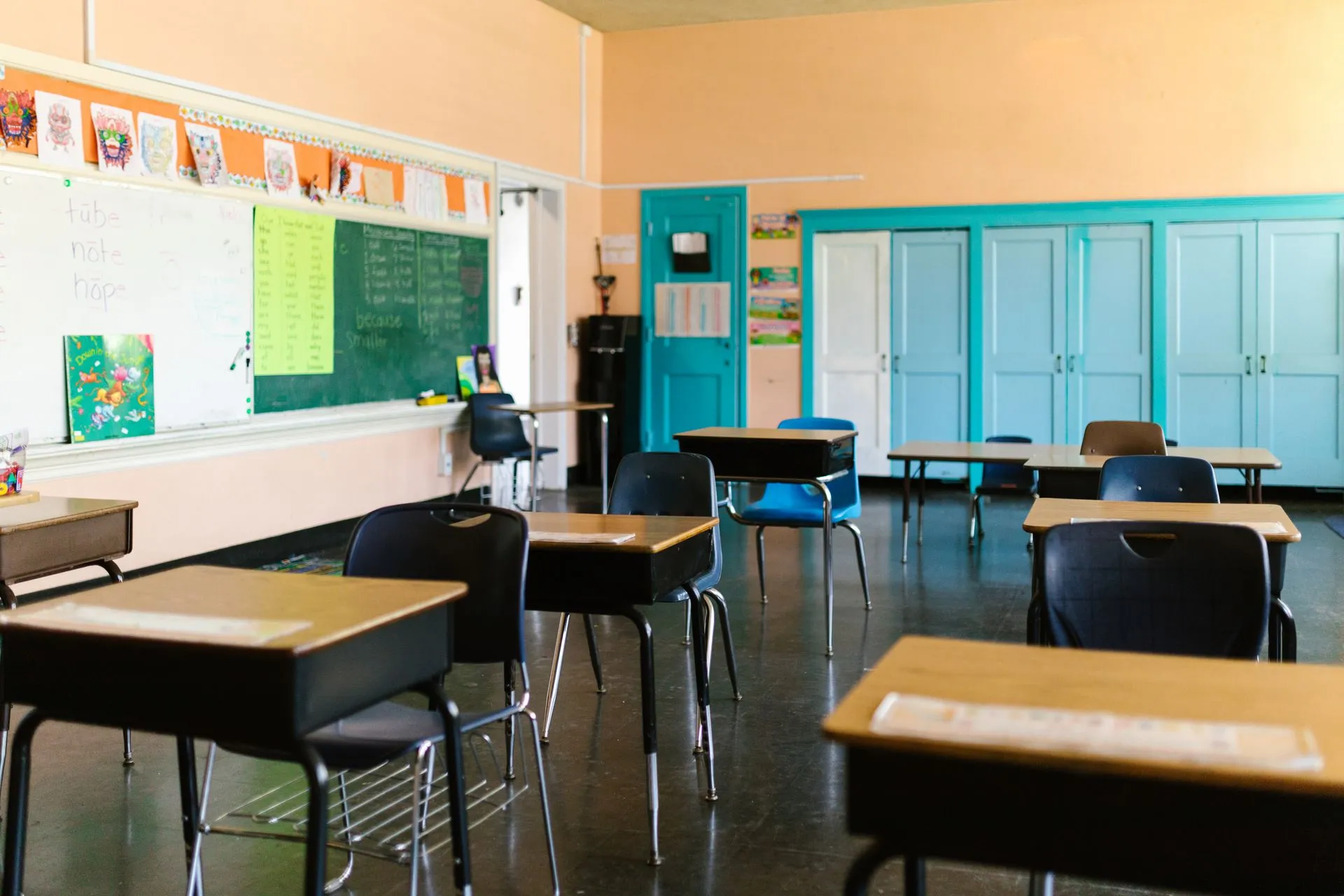 Bright and colorful empty classroom with desks, blackboard, and educational materials, illustrating Frontline Education breach exposes school staff data