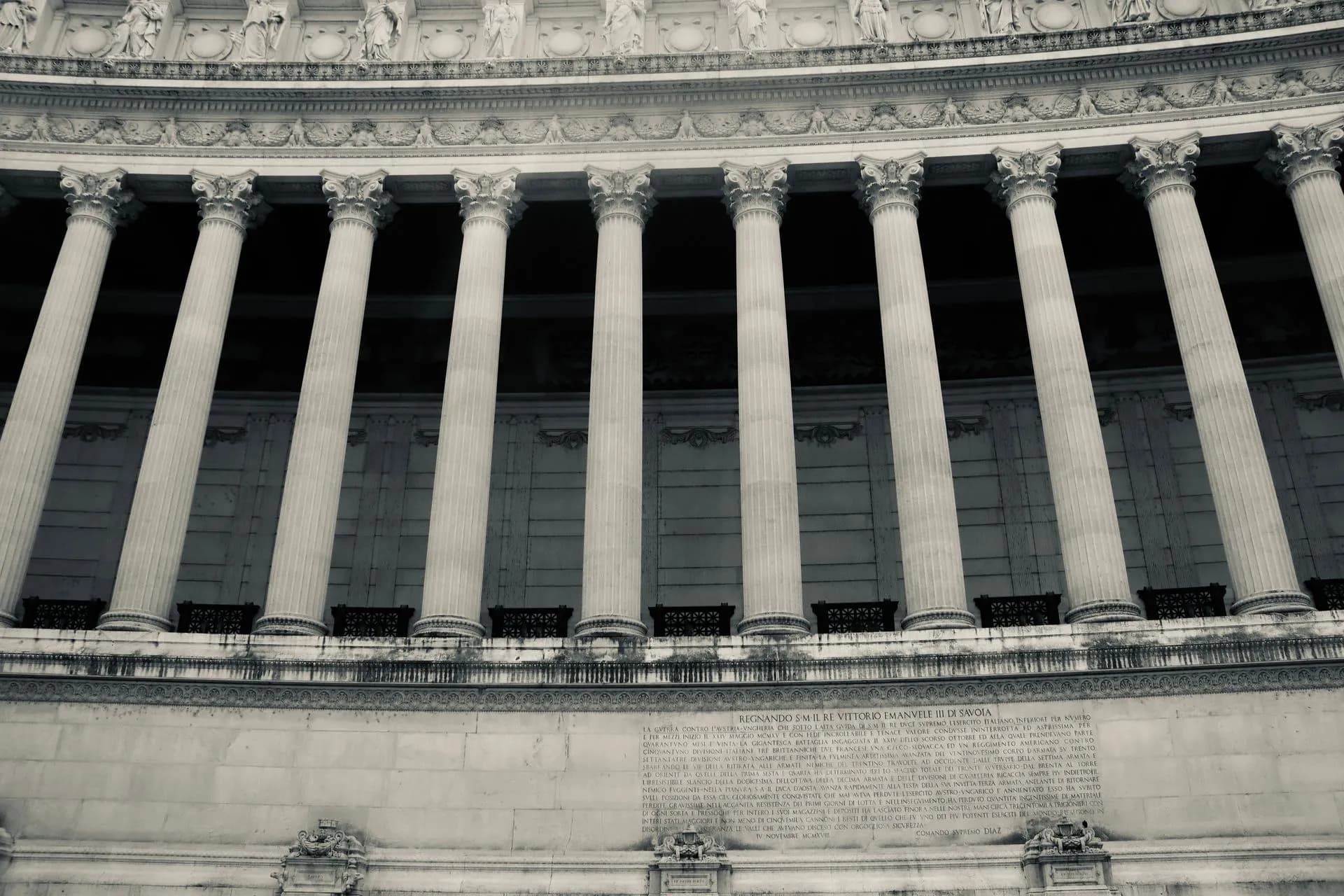 Detailed view of neoclassical columns in a government building facade, illustrating OpenAI and Anthropic face FTC investigation over AI risks to consumers, agency confirms