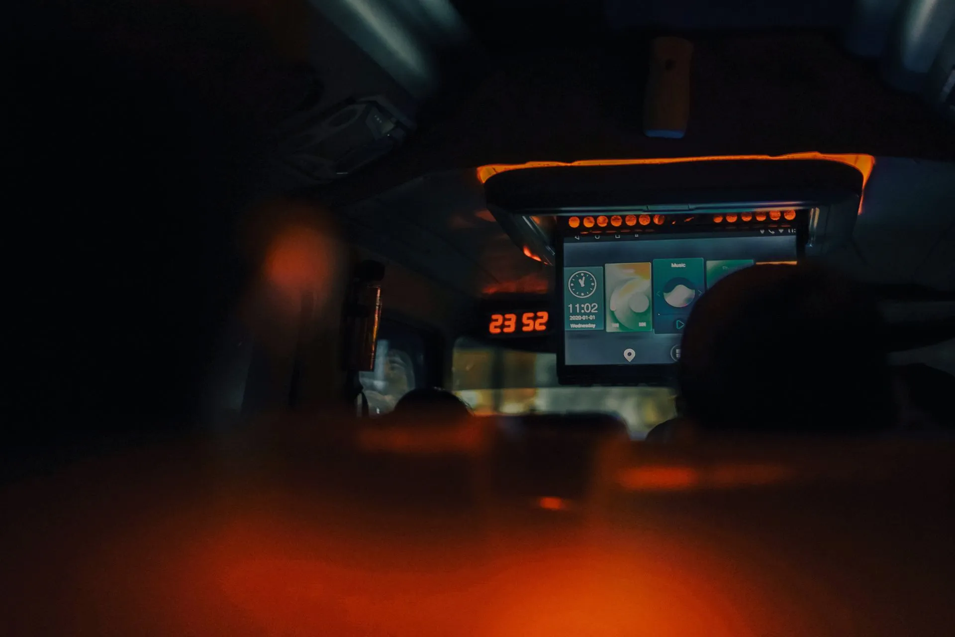 A dimly lit bus interior showcasing screens and ambient lighting during night travel, illustrating Google ad tech remedies trade a breakup for six years of court-supervised
