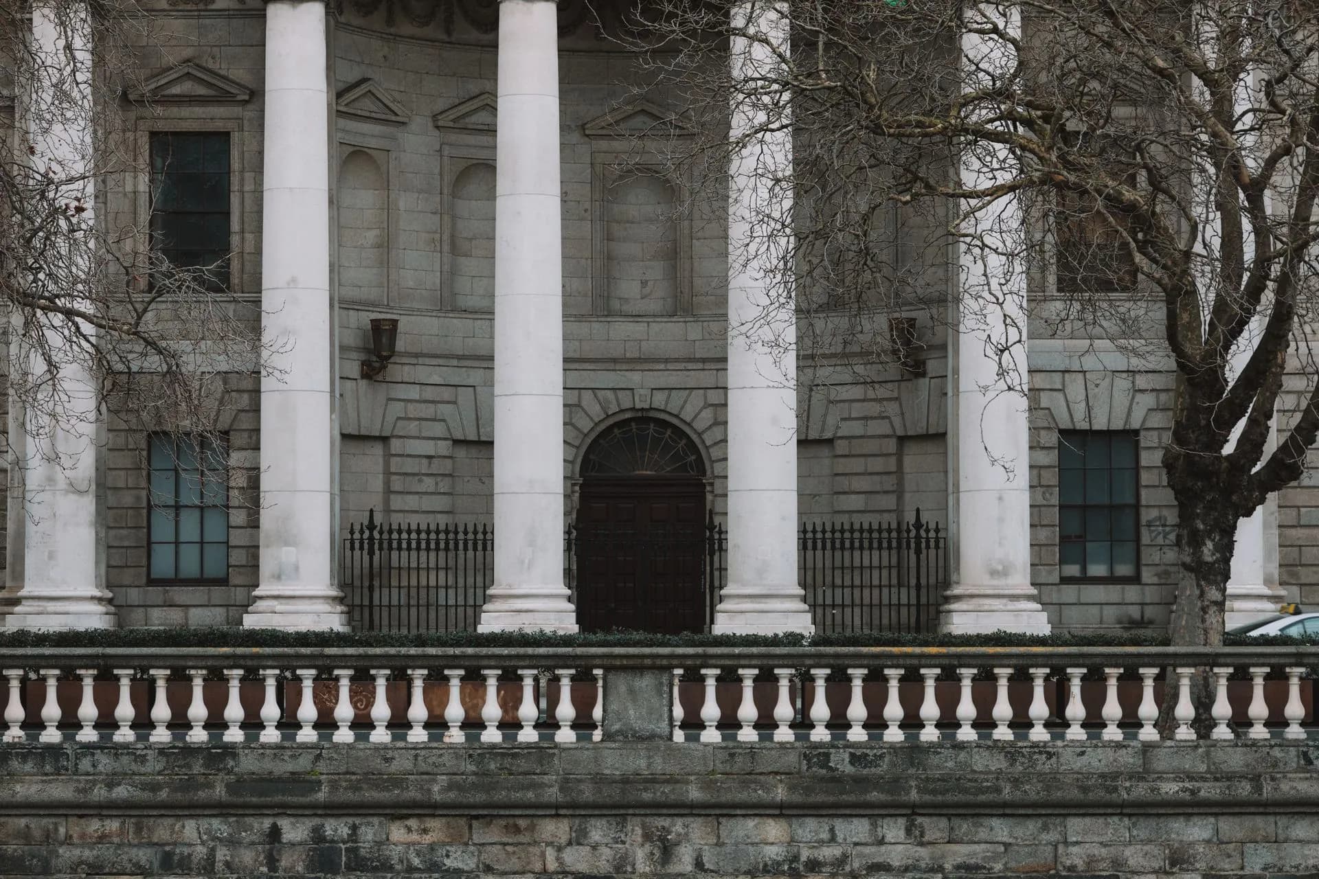 Elegant neoclassical facade of Dublin's Four Courts with iconic white columns, illustrating Google AI Overviews antitrust suits from Chegg and Penske Media dismissed