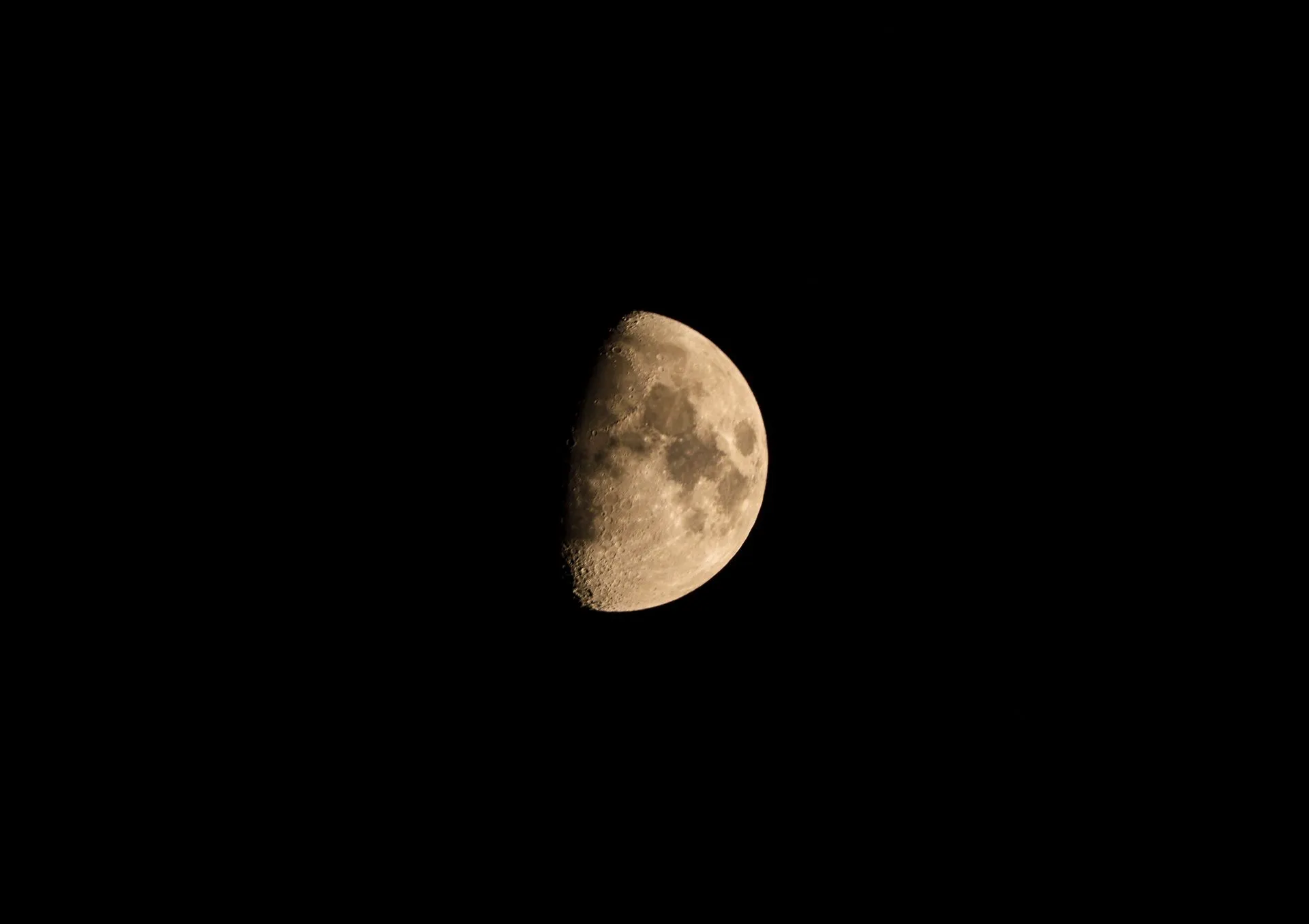 Crisp and clear image of the half-moon against a dark night sky, showcasing crater details, illustrating Google launches first Suncatcher AI satellite