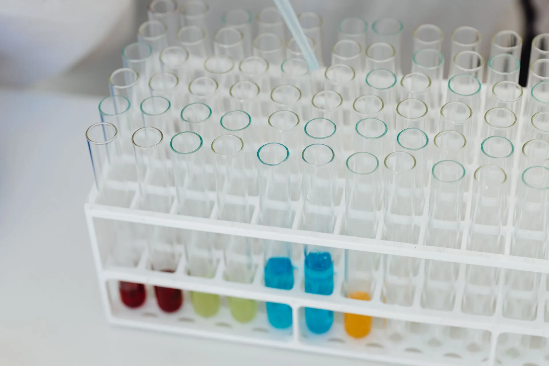 Close-up of a laboratory test tube rack with colorful chemical solutions, emphasizing scientific research, illustrating Labcorp settlement with 44 attorneys general sets $2.3 million