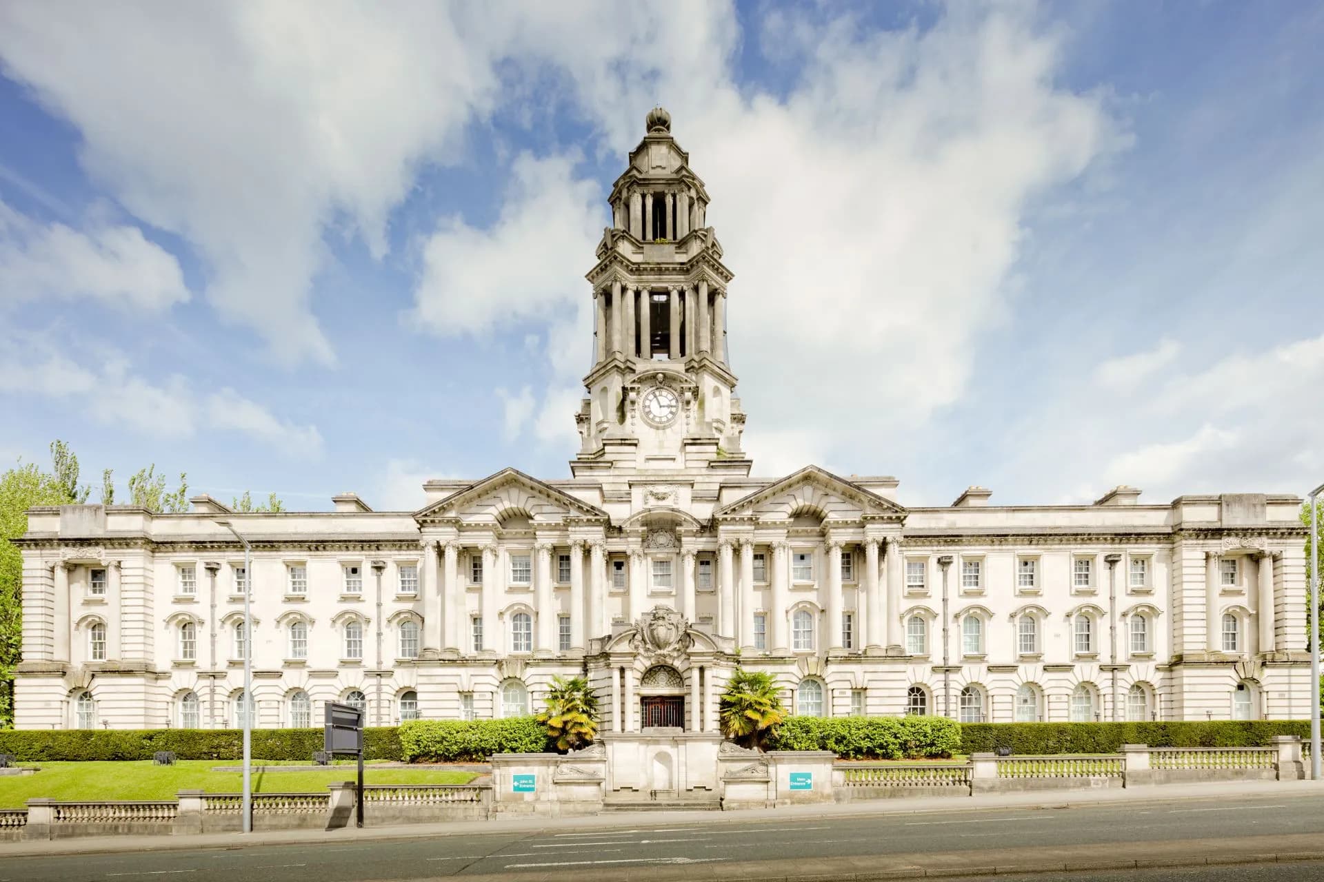 Front view of the iconic Stockport Town Hall with a clear blue sky backdrop, illustrating Local government AI moves past hype into a governance and IT staffing squeeze, study finds