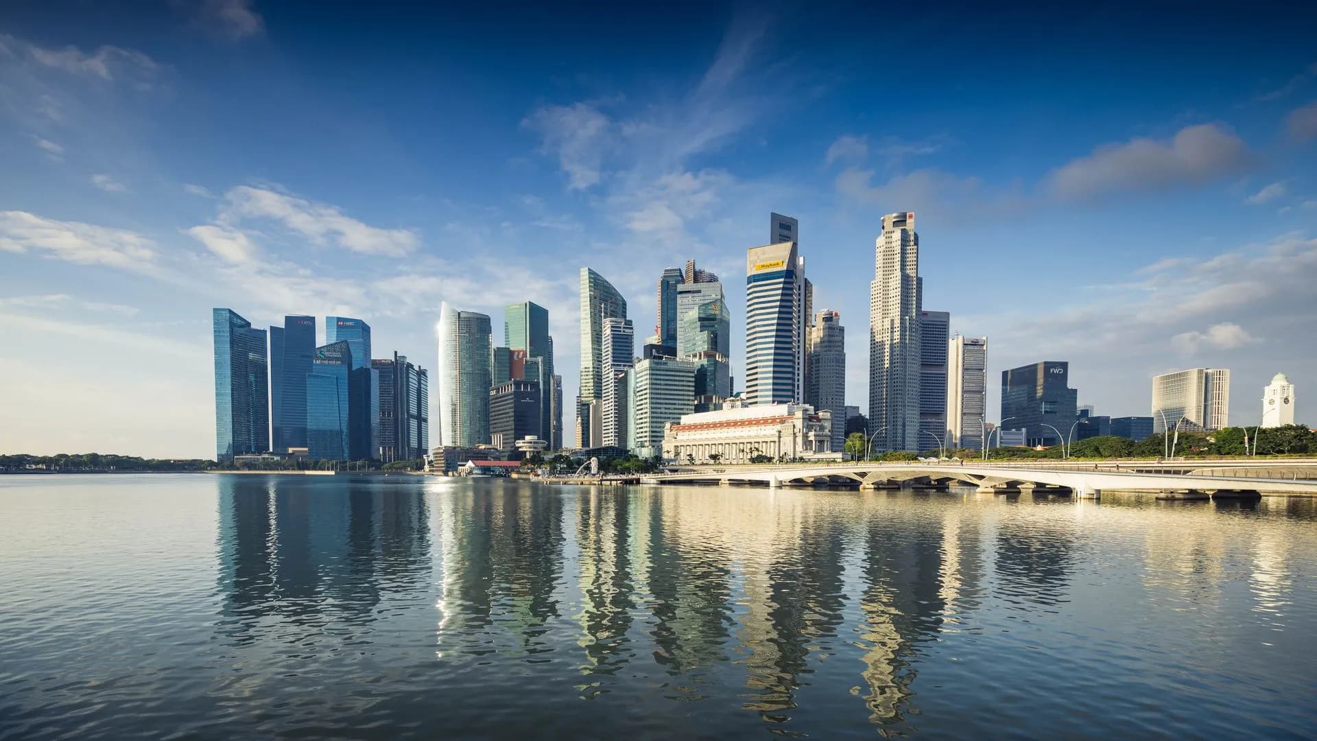 Capture of Singapore's modern skyline featuring reflective skyscrapers against a blue sky, illustrating MAS AI risk management guidelines require independent checks on high-risk bank AI