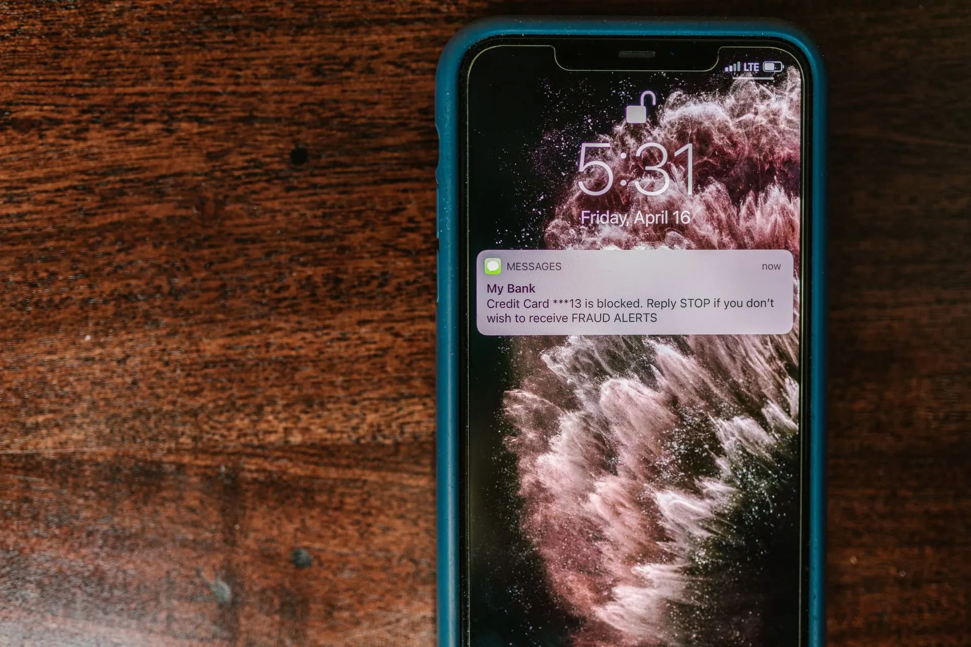 Close-up of smartphone displaying a fraud alert message on wooden surface, illustrating Meta anti-scam campaign reached 303 million people in 18 Asia-Pacific countries, Meta says