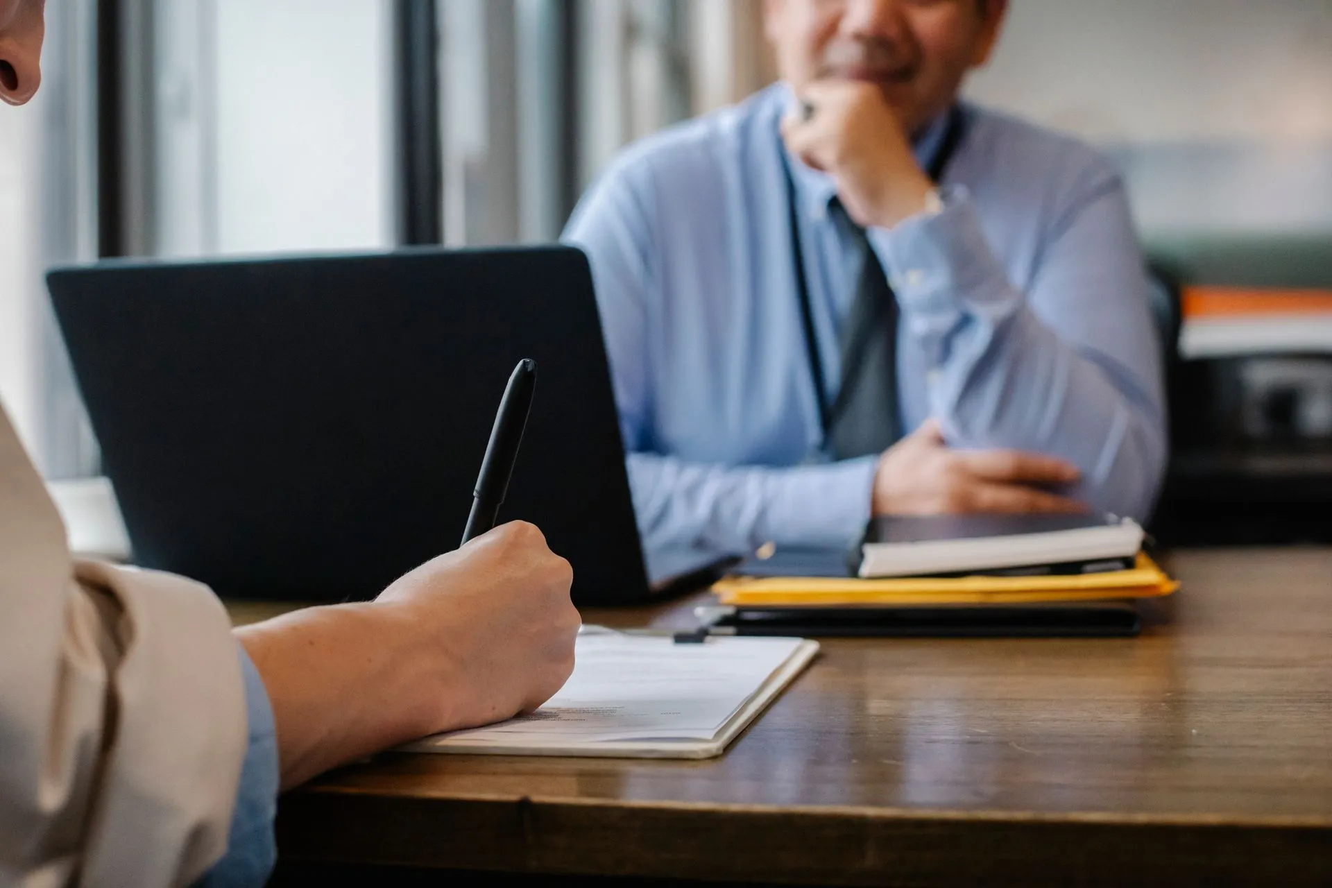Crop anonymous female filling questionnaire when applying for job sitting in employer office, illustrating Metaview raises $60M Series C led by Insight Partners to automate recruiting