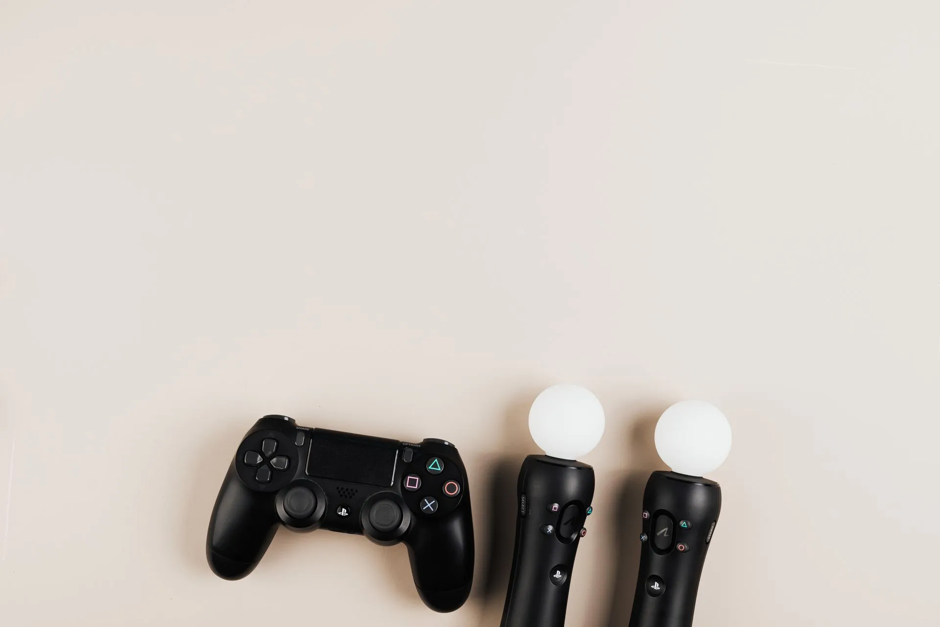 Black gaming controllers arranged on a light background with ample copy space, illustrating Microsoft's Xbox layoffs hit 268 more roles as Halo moves to Activision