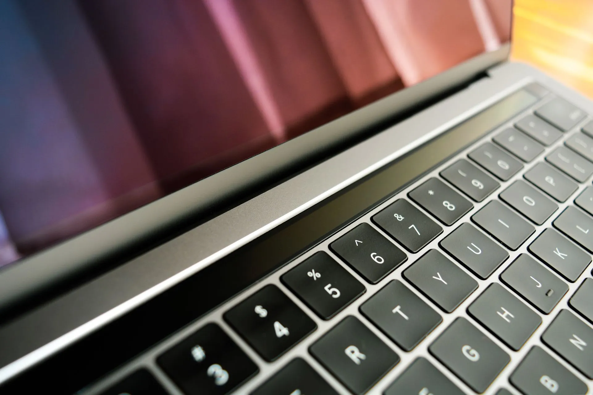Detailed close-up of a sleek, modern laptop keyboard with a reflective screen, emphasizing technology and design, illustrating MonsterCloud CEO charged with secretly paying ransoms while