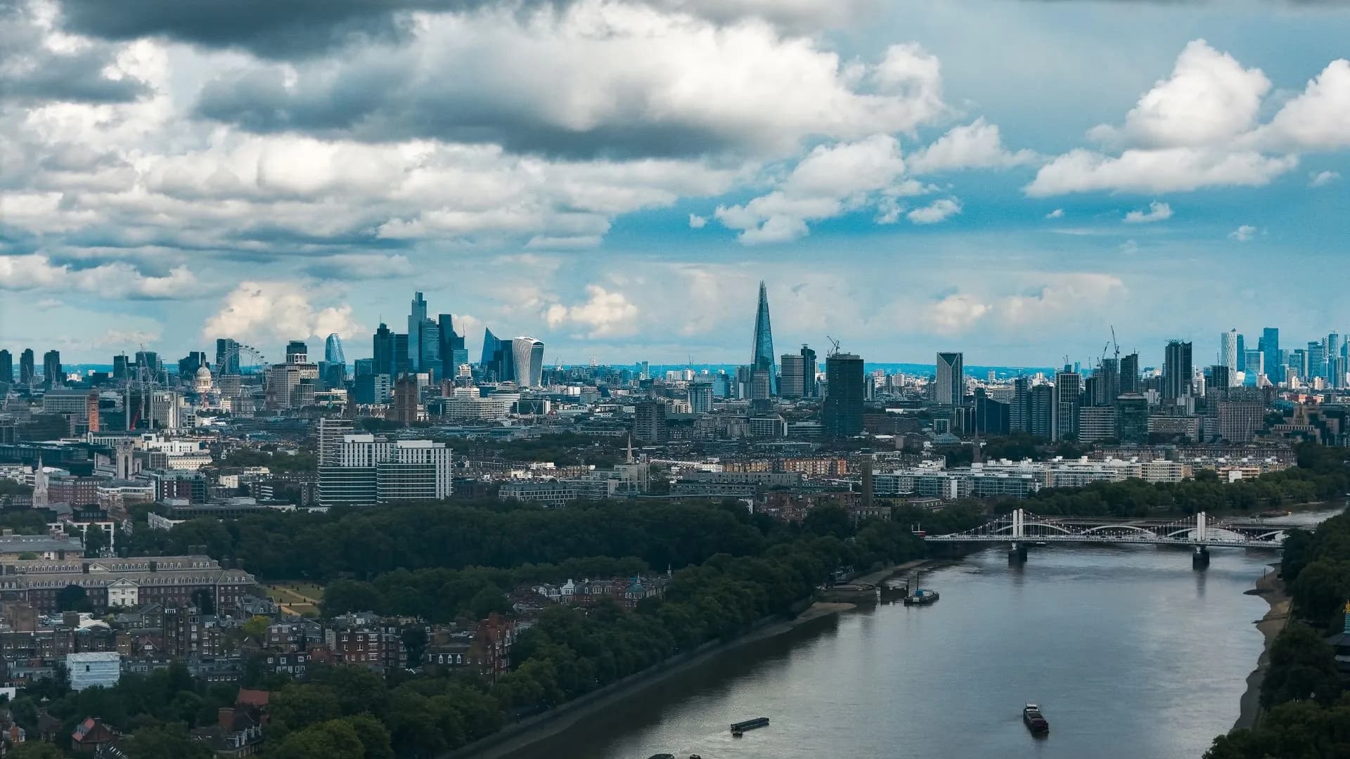 Wide-angle view of London's modern skyline and River Thames under a dramatic sky, illustrating Monzo Nubank talks could value UK digital bank at up to £10 billion, reports say