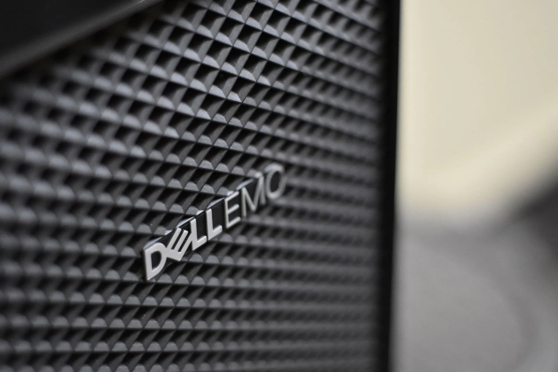 Detailed close-up of Dell EMC server logo on hardware grill with shallow focus and textured patterns, illustrating NetApp Oracle cloud storage deal aims to give Oracle what AWS, Azure