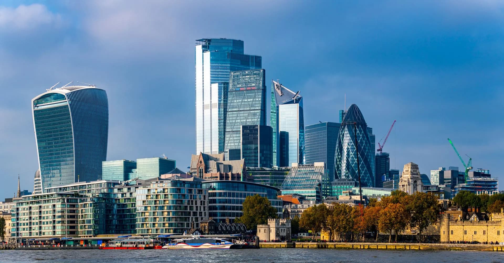 Stunning view of the London skyline featuring iconic skyscrapers along the River Thames, illustrating Nuveen completes Schroders acquisition, creating a $2.6 trillion asset and wealth