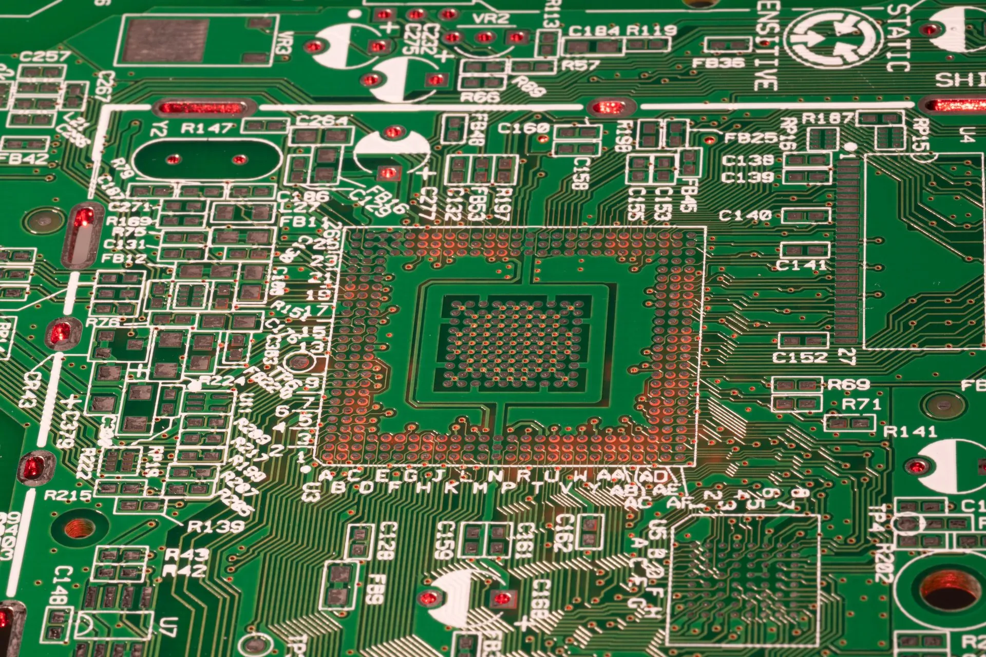Detailed view of a green printed circuit board with visible components and connections, illustrating Nvidia's $150 billion buyback authorization leads a three-way split in chipmaker