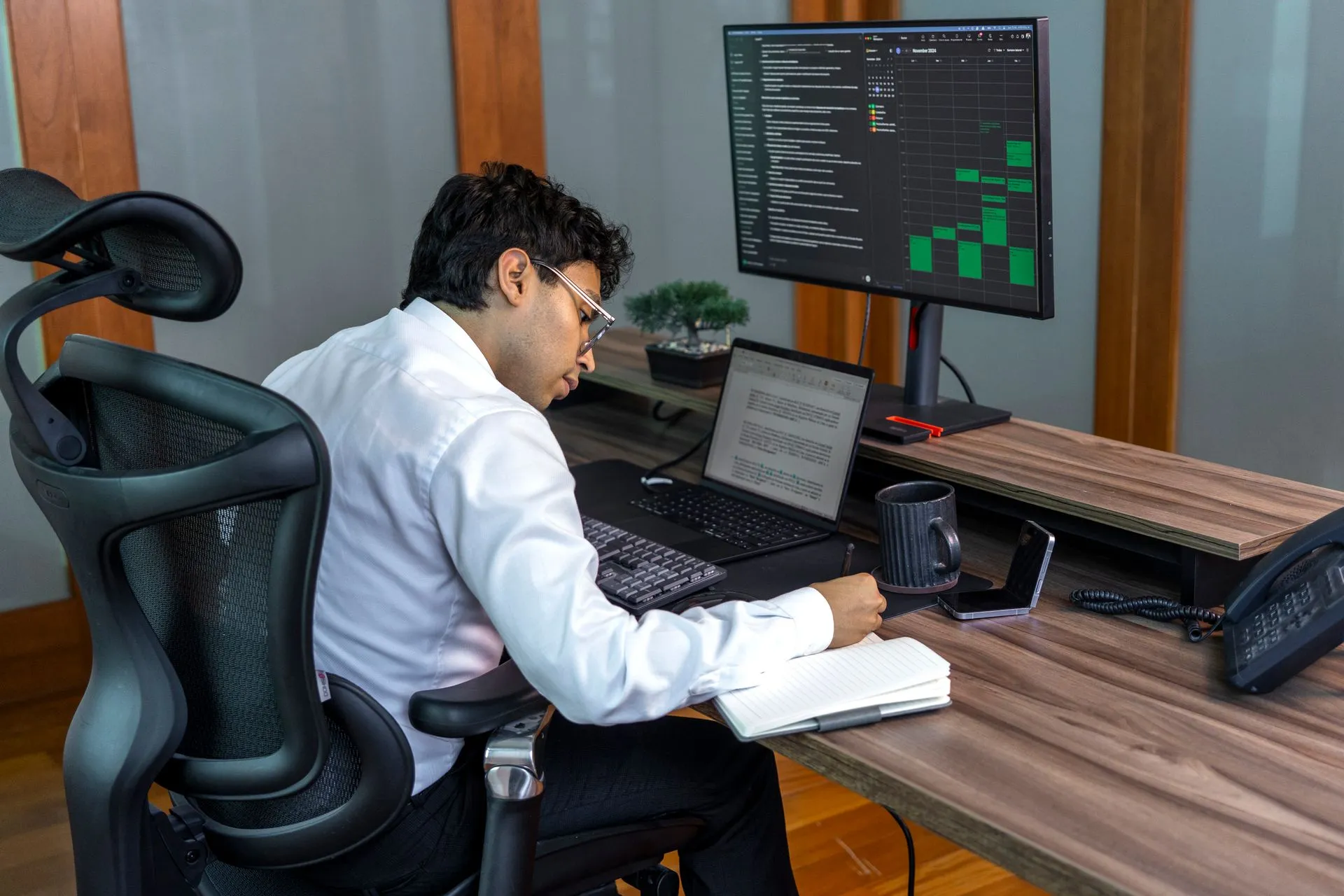 A focused professional analyzing data on computer in a modern office setting, illustrating Nvidia Kumo Tabular, a free model needing no training, claims top spot on four benchmarks