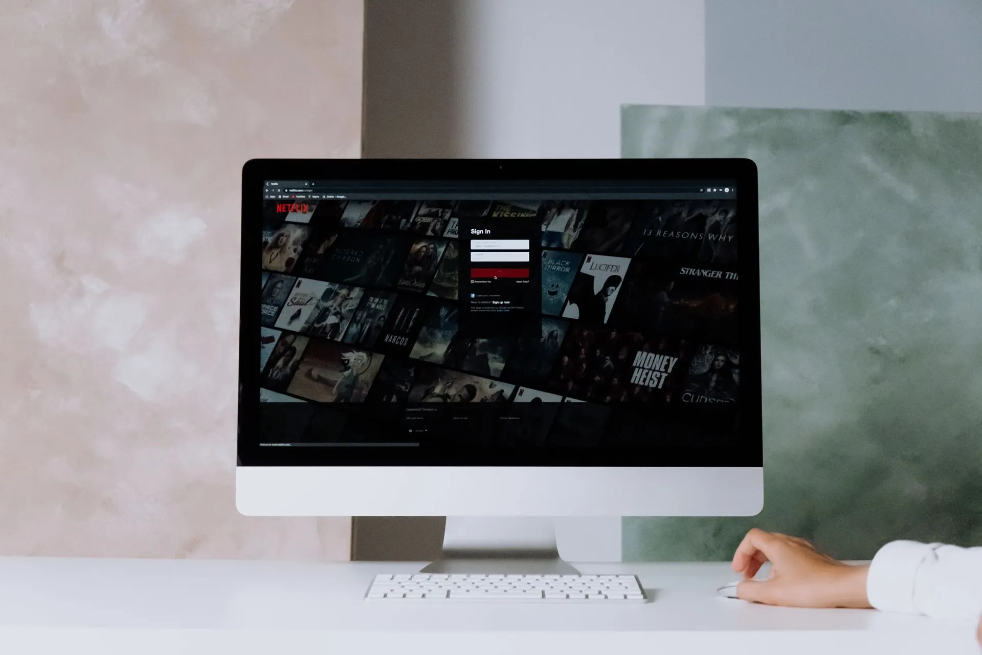 A modern desktop displays a streaming service interface, showcasing entertainment options in a minimalist office setting, illustrating Okta AI agent security push adds Agent SSO, plans gateway