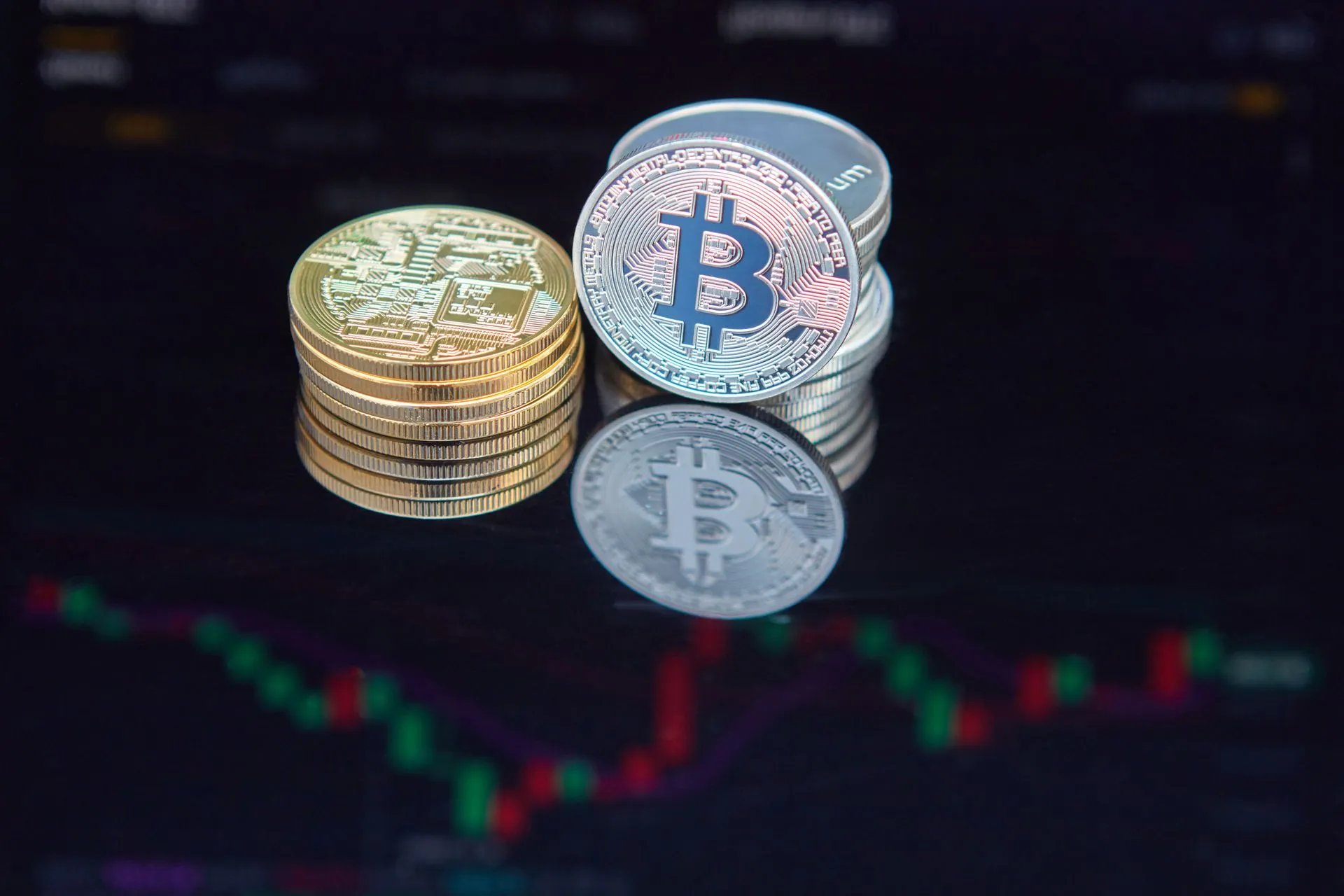 Close-up of bitcoin coins reflecting on a screen with financial market data, highlighting digital currency trend, illustrating OpenAI funding round of at least $30 billion would value it