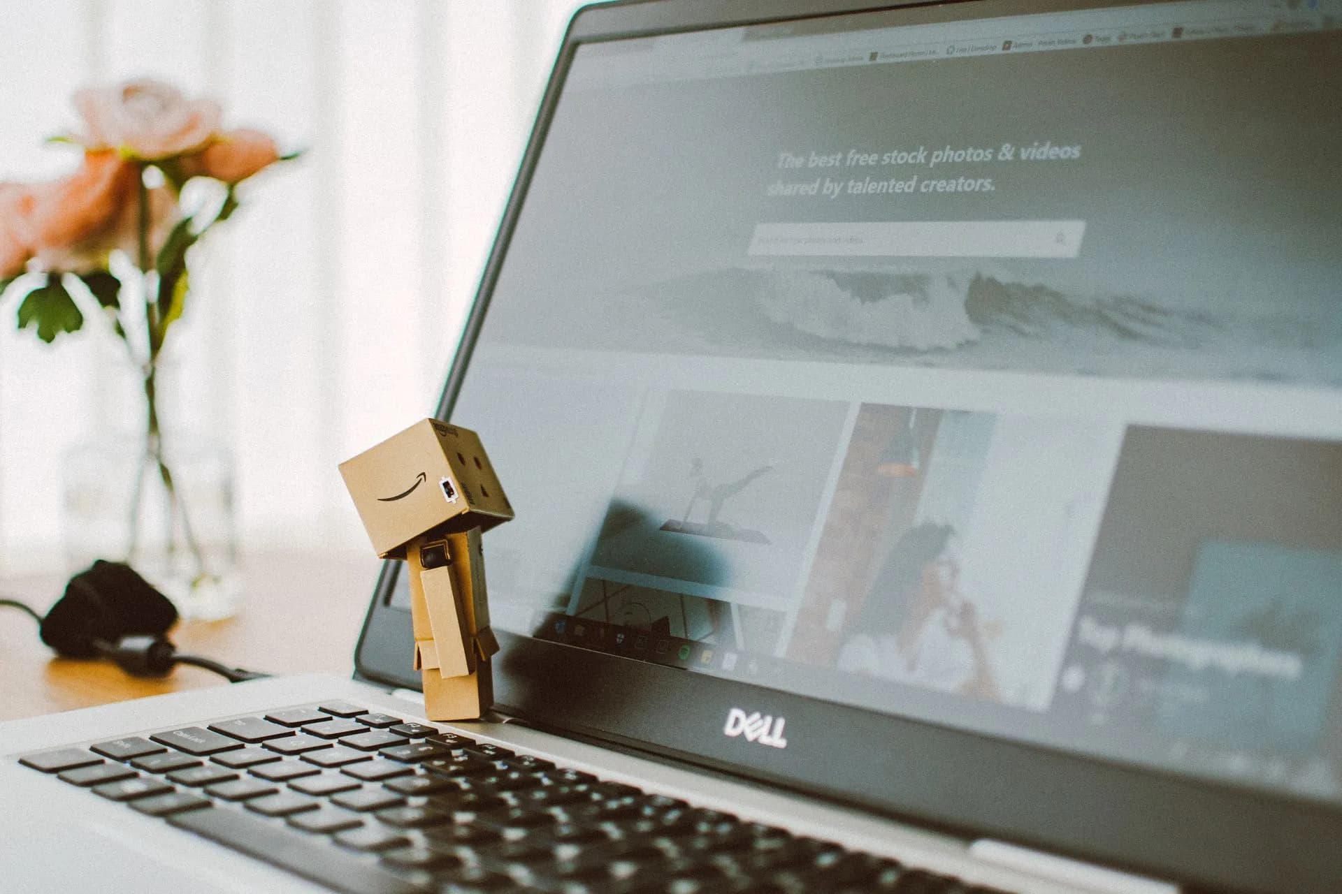 A small toy figure stands on a laptop keyboard with flowers in the background, illustrating OpenAI Medicare breach