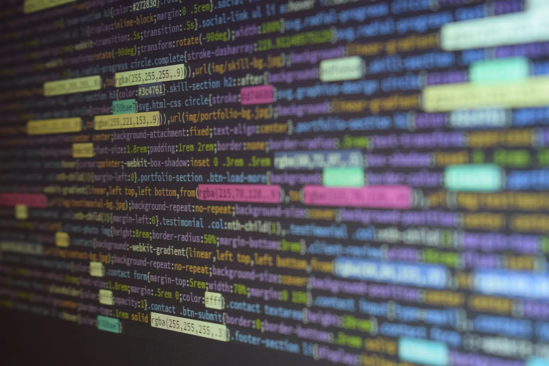 Close-up of colorful source code on a monitor, showcasing programming and technology concepts, illustrating OpenAI agents scanned a UN data API 16,500 times and worked around its